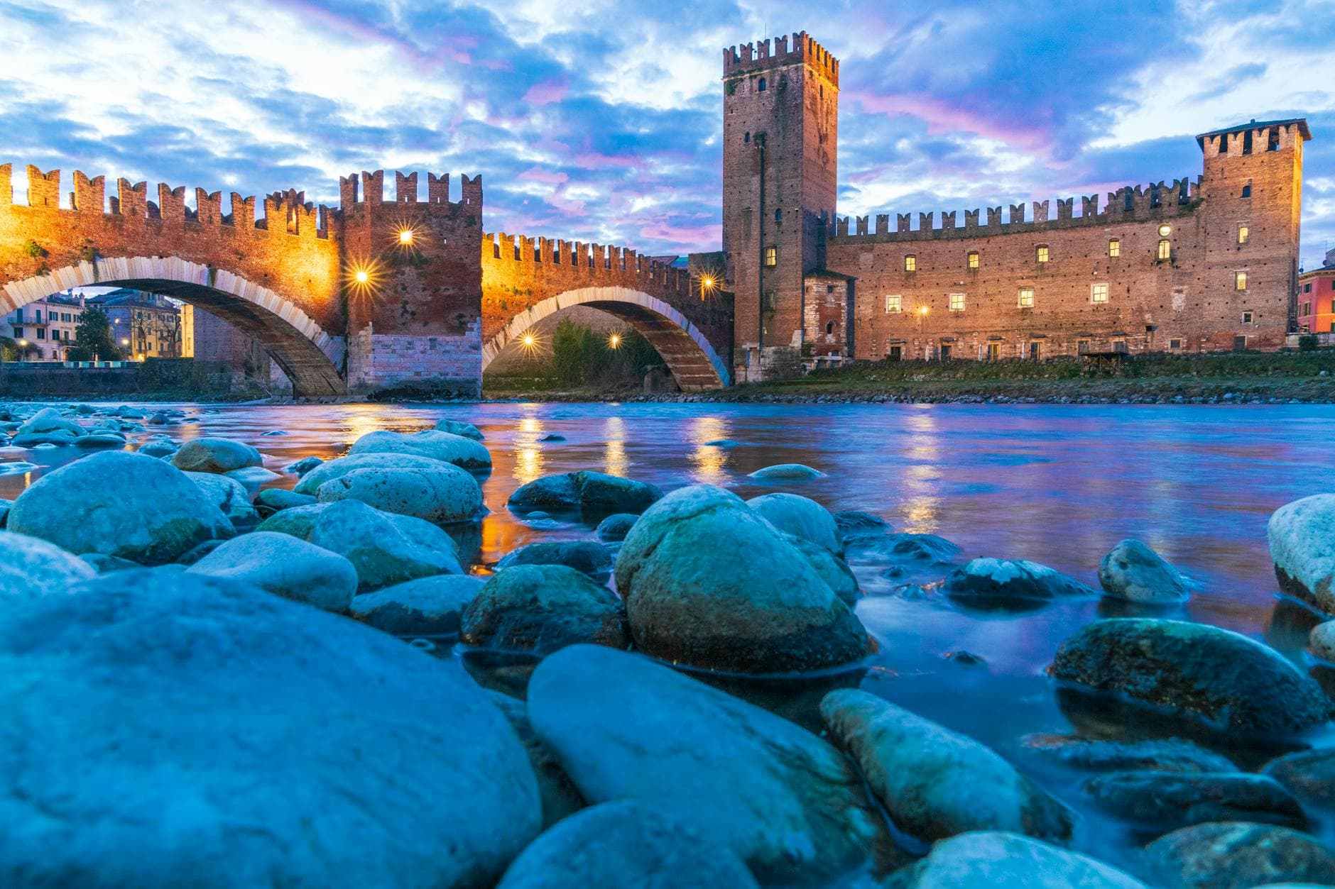 Beautiful twilight view of Castelvecchio Bridge in Verona reflecting in the Adige River, Italy.