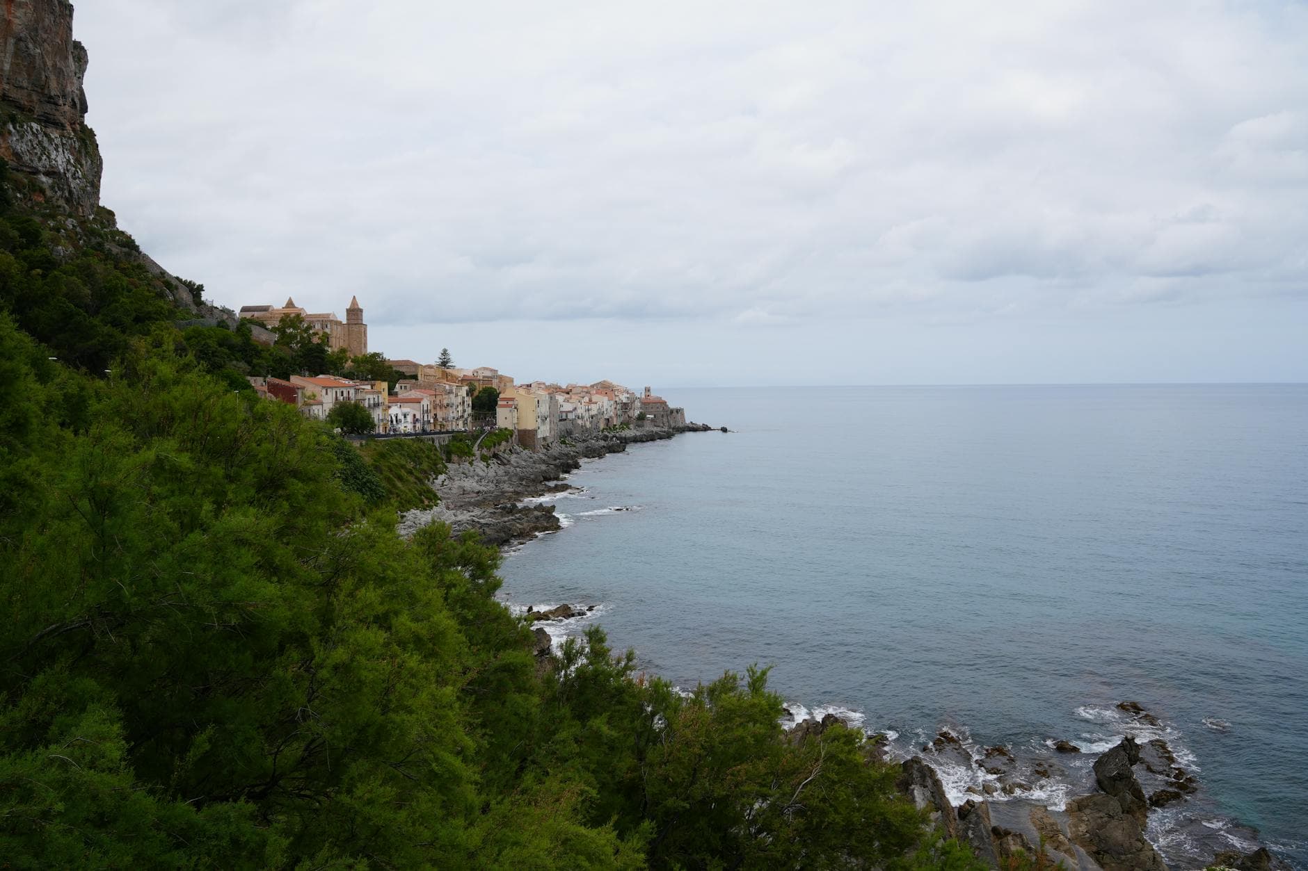 Discover the breathtaking coastal charm of Cefalù, Sicily, with its historic architecture and stunning sea view.