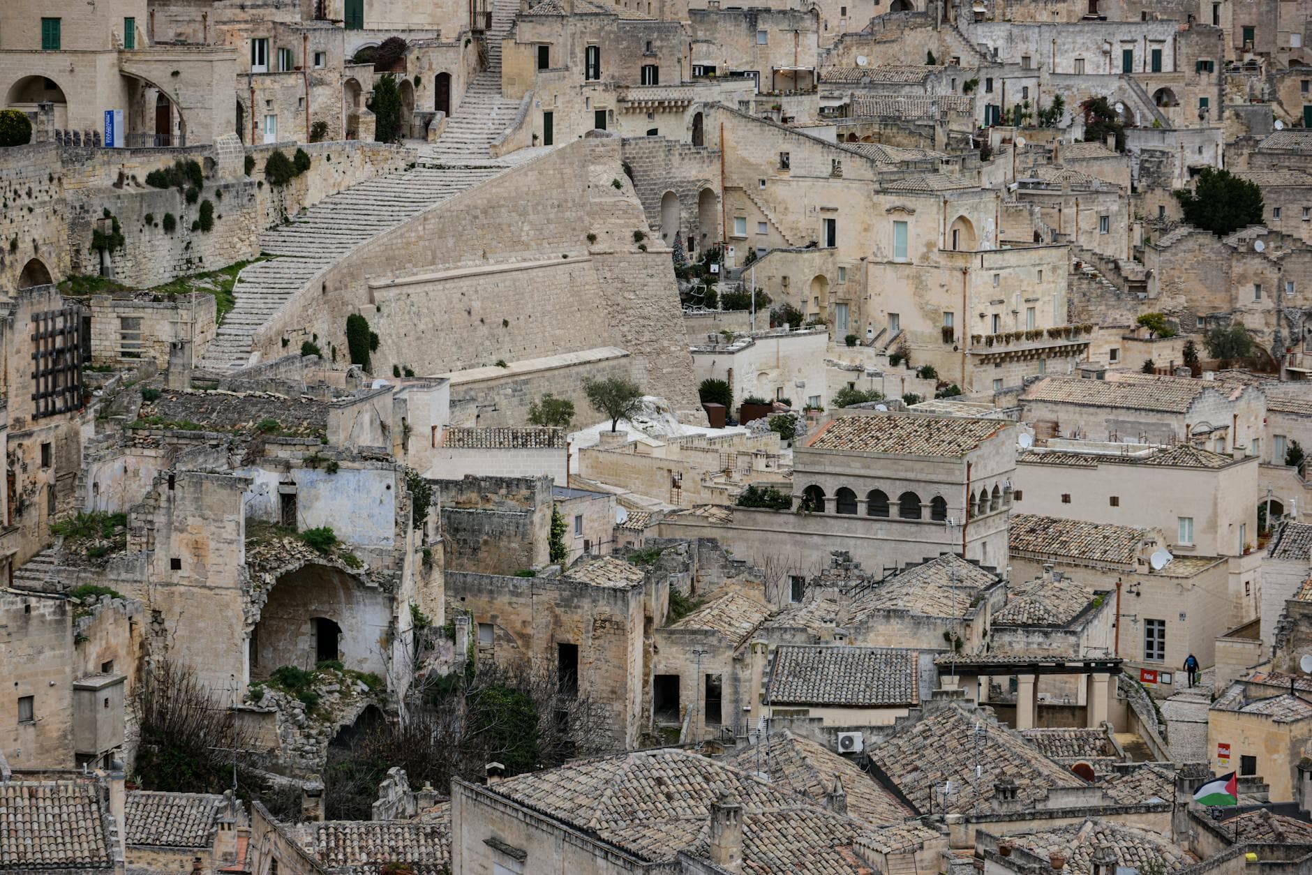 Explore the ancient stone buildings and winding stairways of Matera, Italy's historic cityscape.
