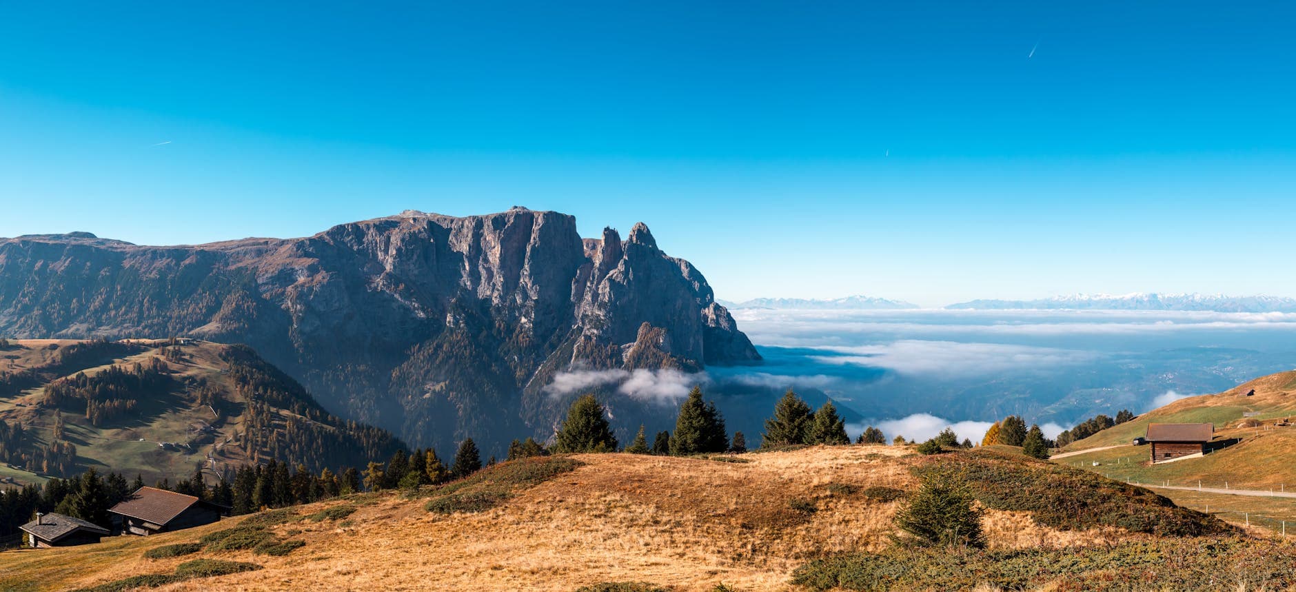 Breathtaking view of Schlern mountains in Trentino-Alto Adige during autumn with clear blue skies.