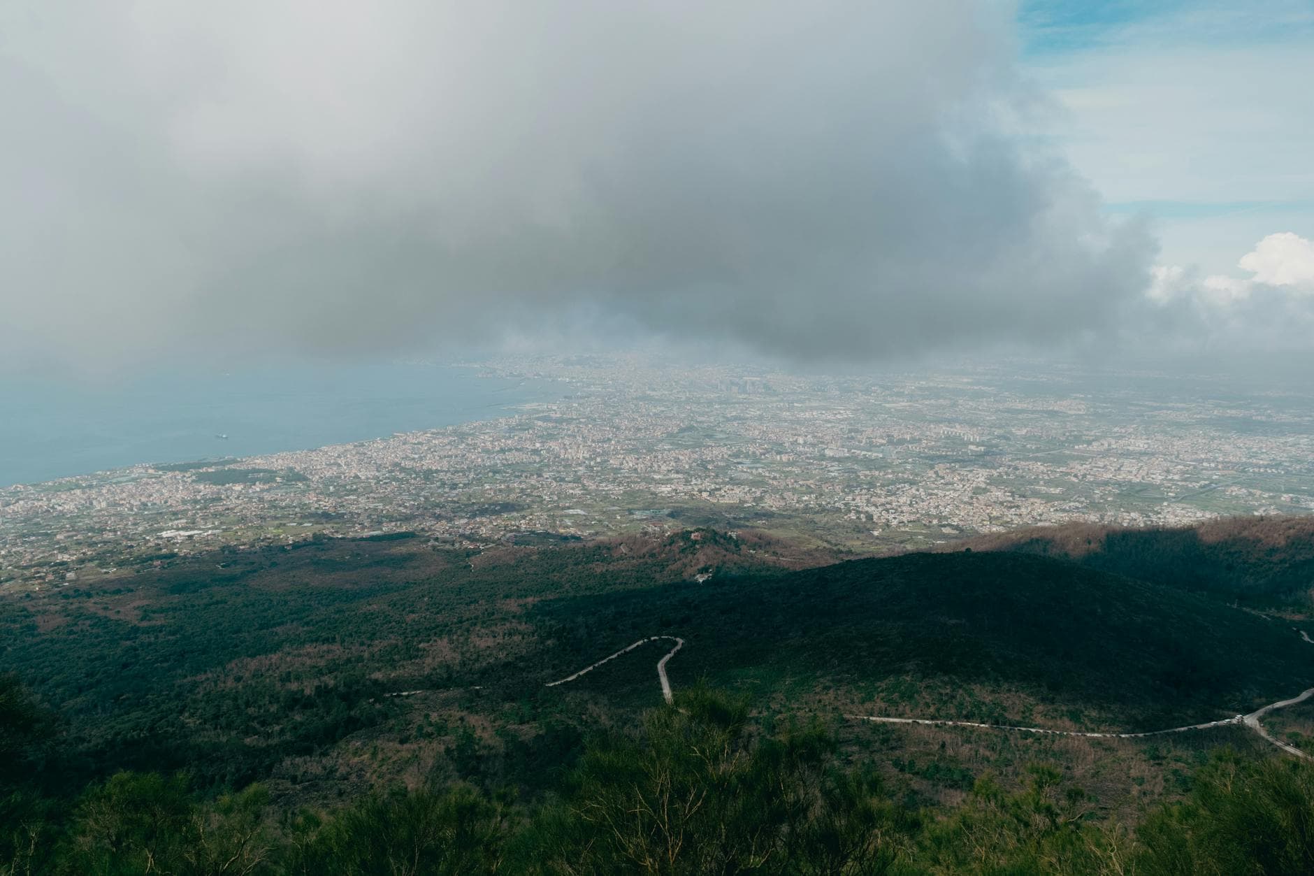 Breathtaking aerial view of Naples, Italy from Mount Vesuvius showcasing a vibrant cityscape and coastal expanse.