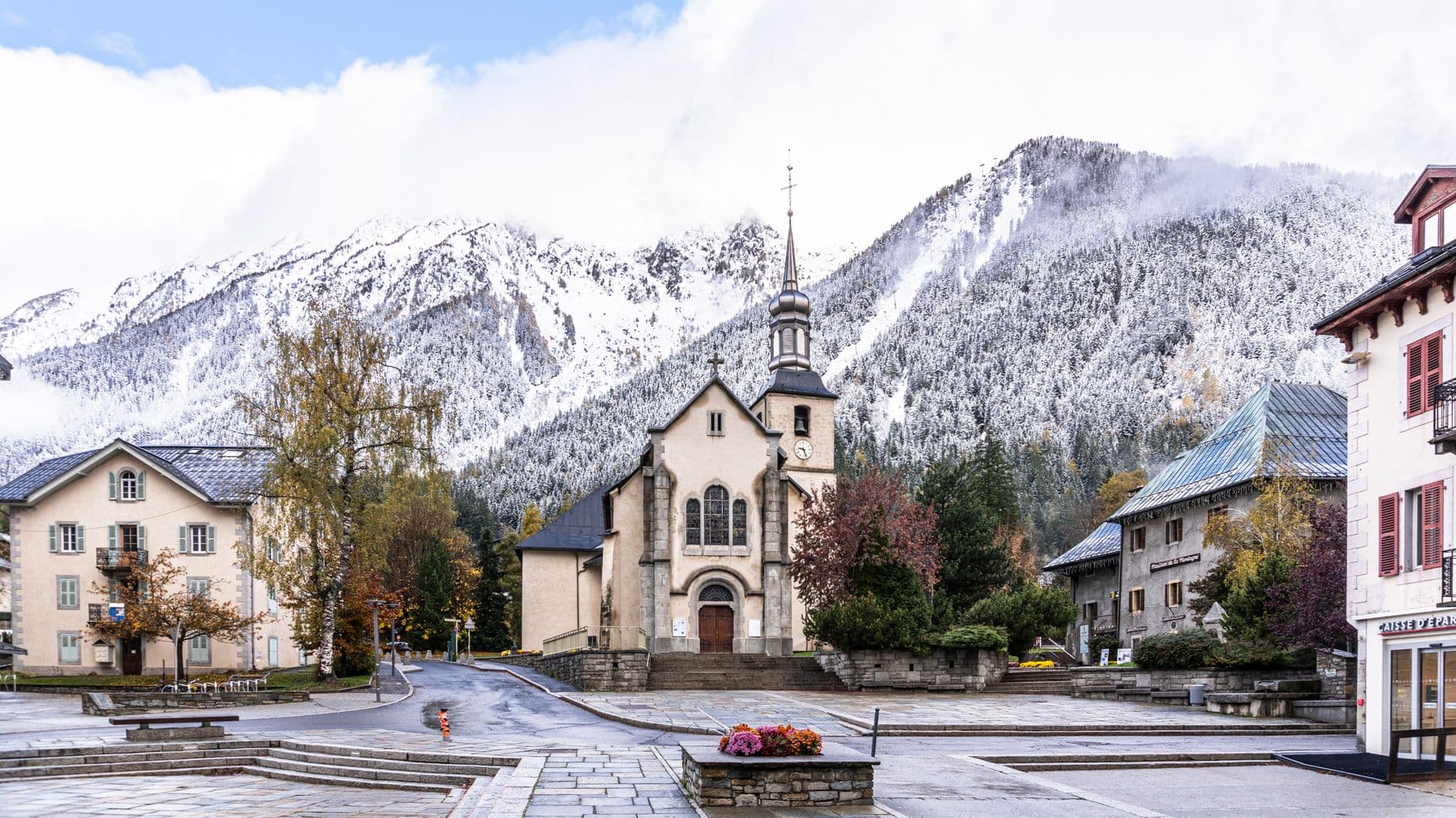 Picturesque view of Chamonix's church and snowy Alps, capturing the town's charming ambiance.
