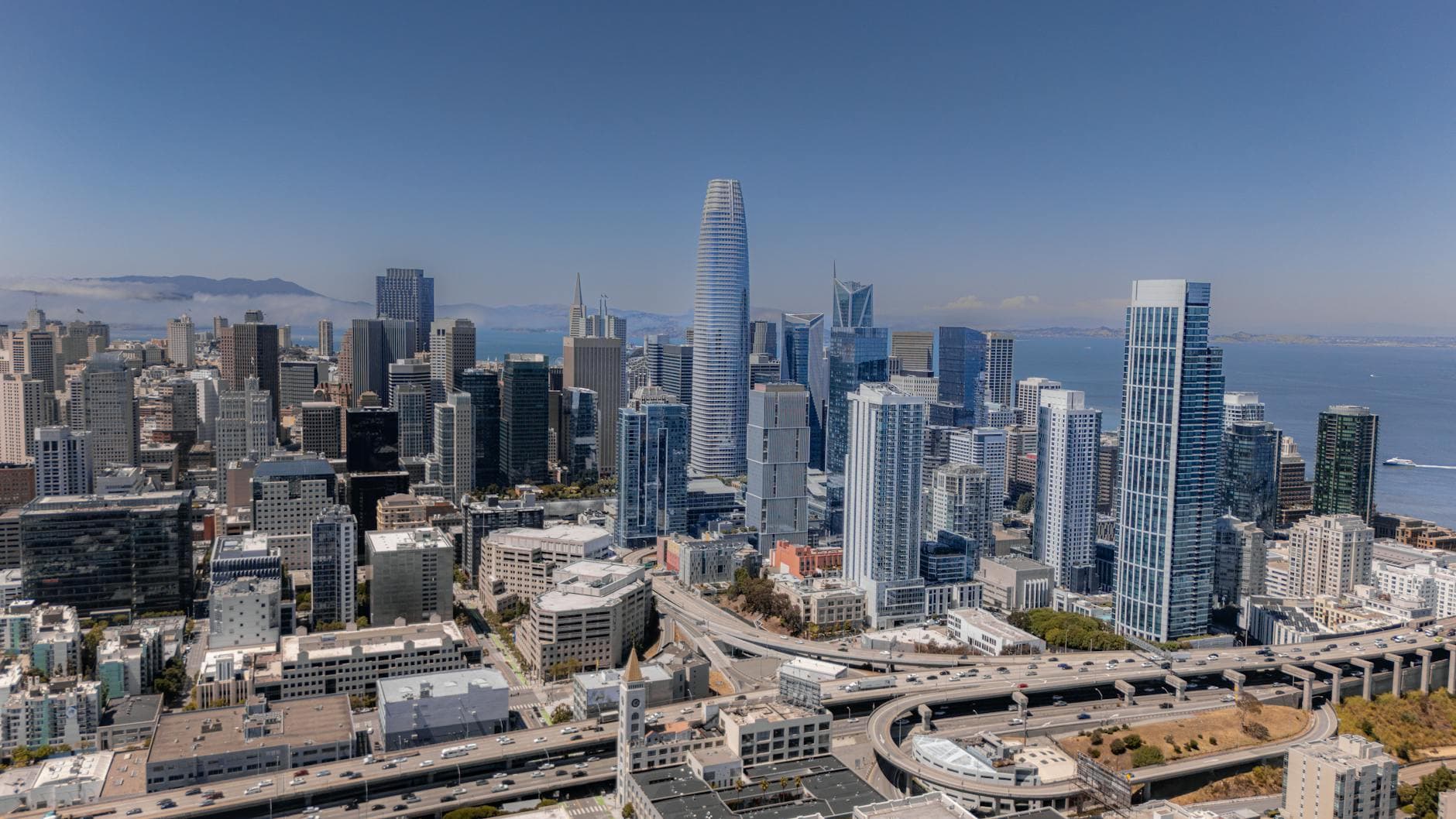 Aerial view of San Francisco skyline featuring iconic skyscrapers and waterfront.