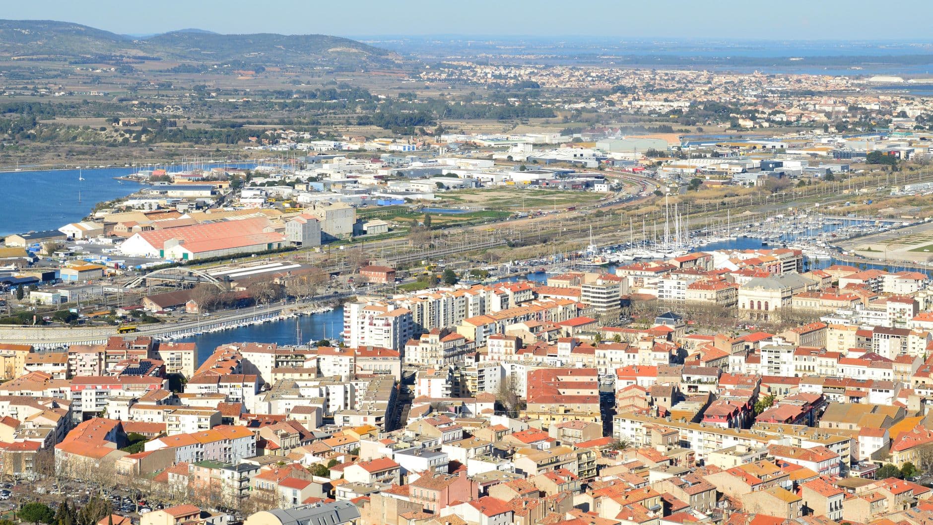 Discover the charming coastal cityscape of Sète, Occitanie, from above.