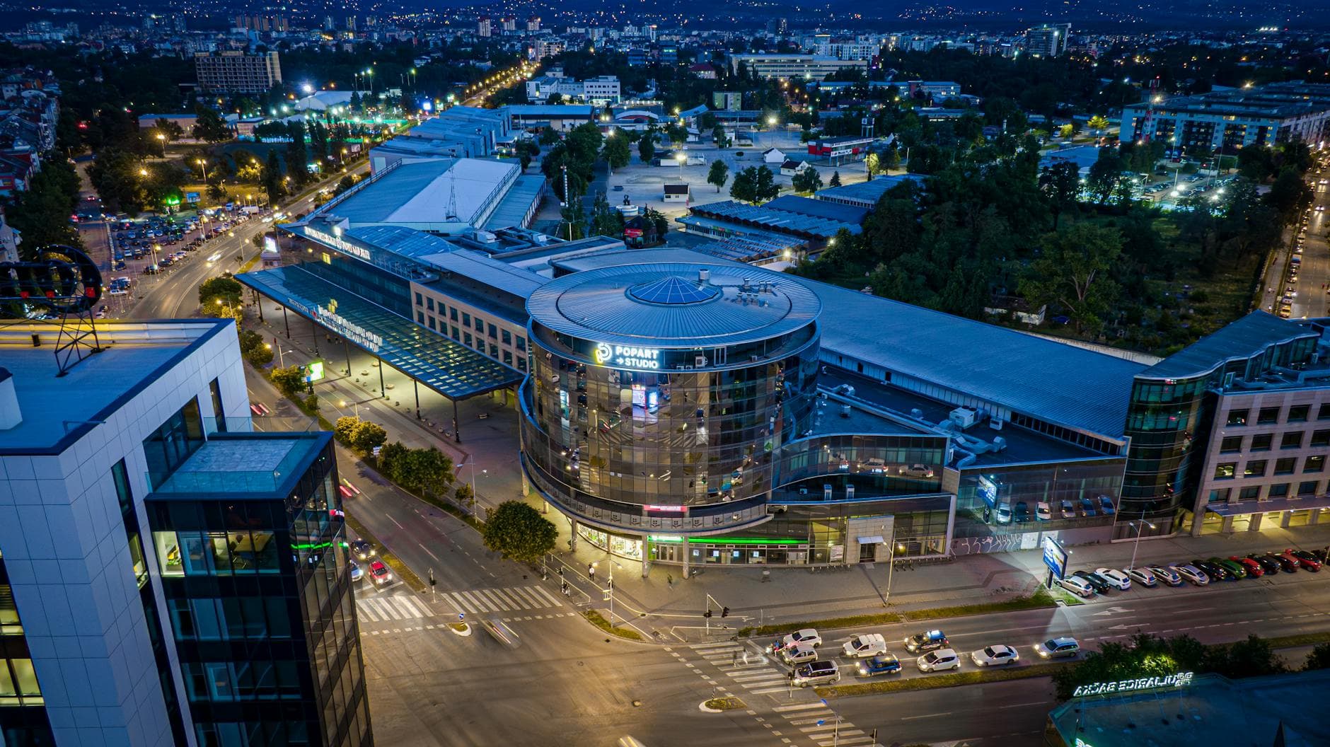 Stunning aerial view of Novi Sad, Serbia, showcasing illuminated city streets and modern architecture.