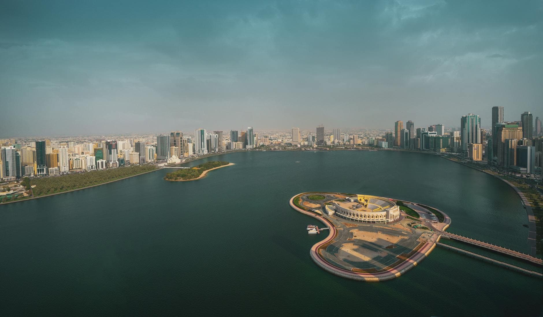 Breathtaking aerial view of Sharjah skyline and Corniche over the Arabian Gulf.