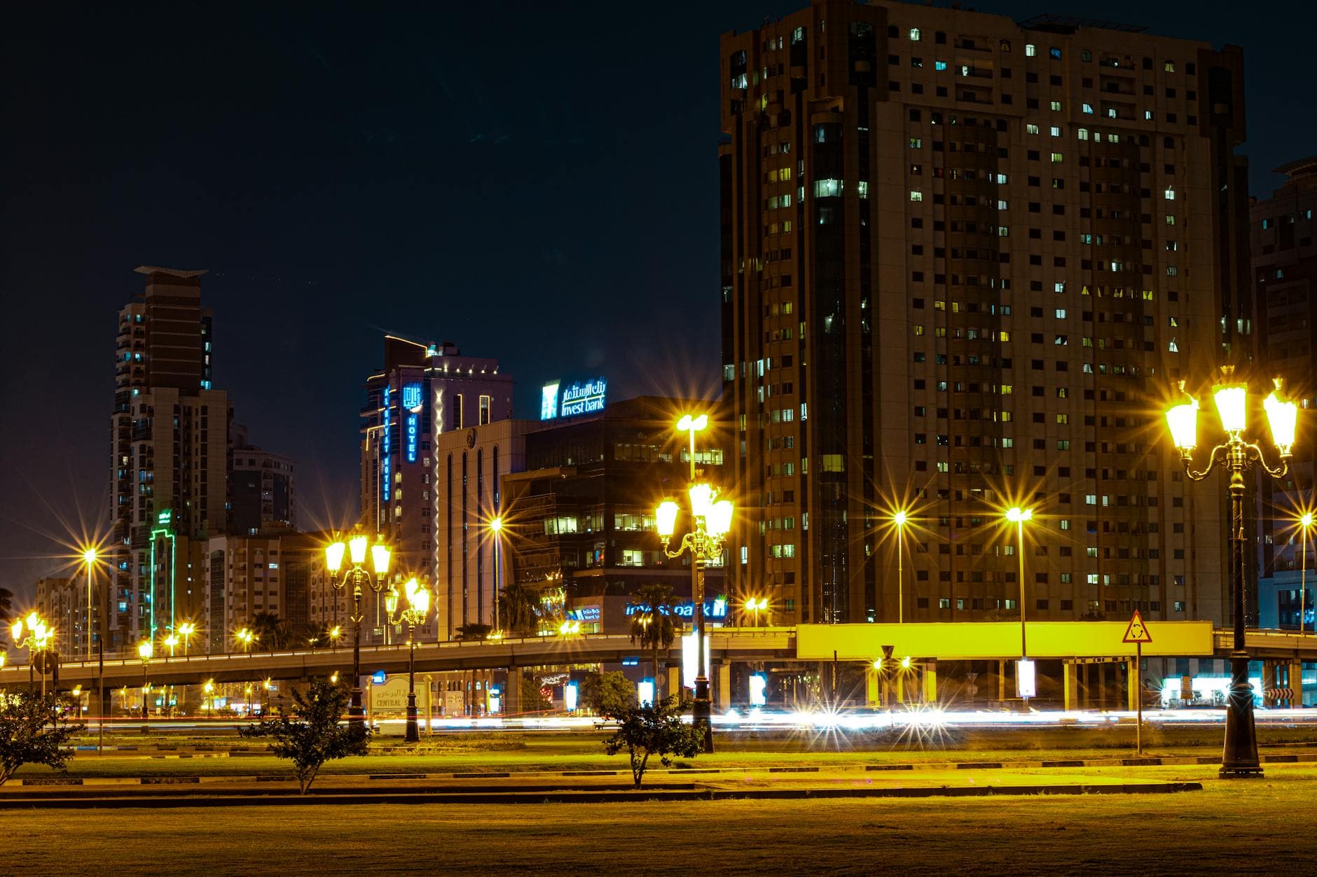 Stunning night view of Sharjah cityscape with modern skyscrapers and lit streets.