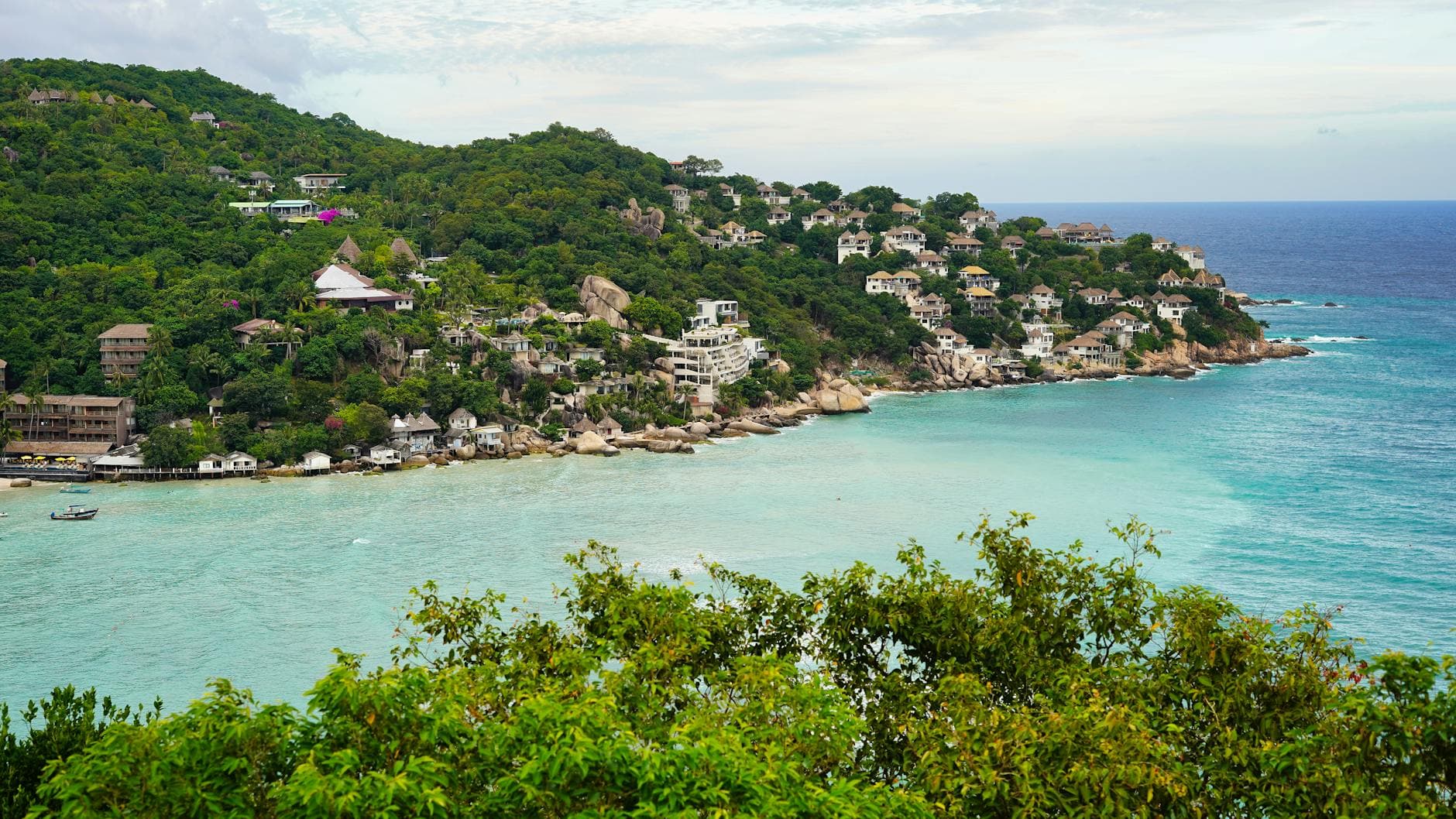 Breathtaking aerial view of Koh Tao's Shark Bay with turquoise waters and lush greenery in Thailand.