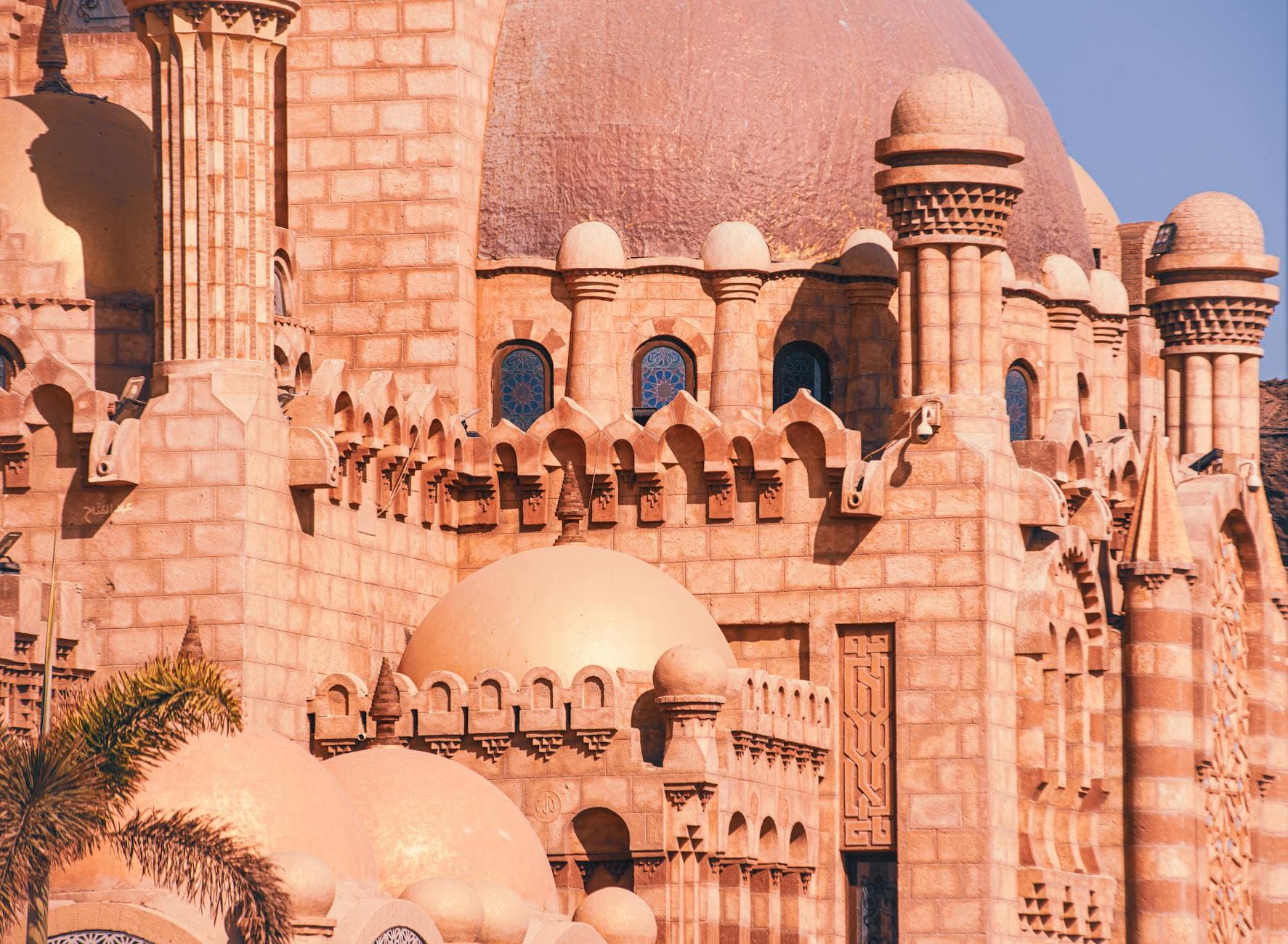 Detailed view of Al Sahaba Mosque's intricate sandstone architecture in Sharm El Sheikh, Egypt.