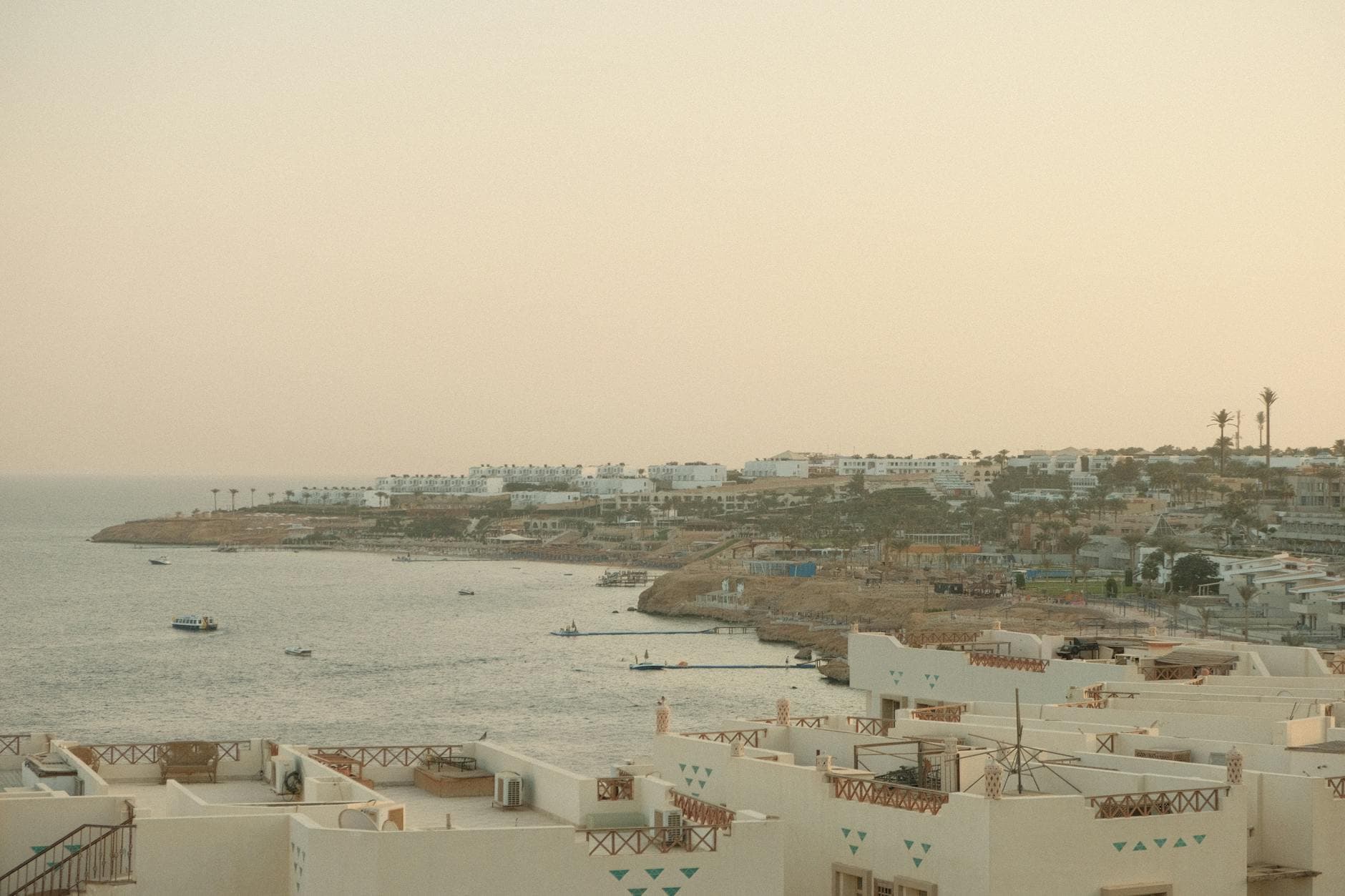 Breathtaking view of Sharm El Sheikh coastline at sunset with calm sea and resort buildings.