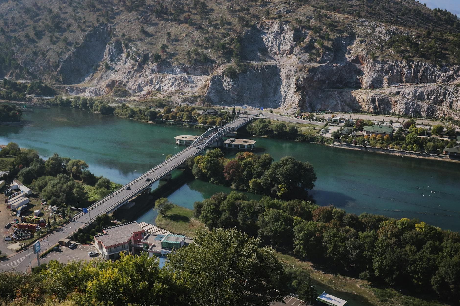 Aerial view of a bridge over a scenic river in Shkodër, Albania.