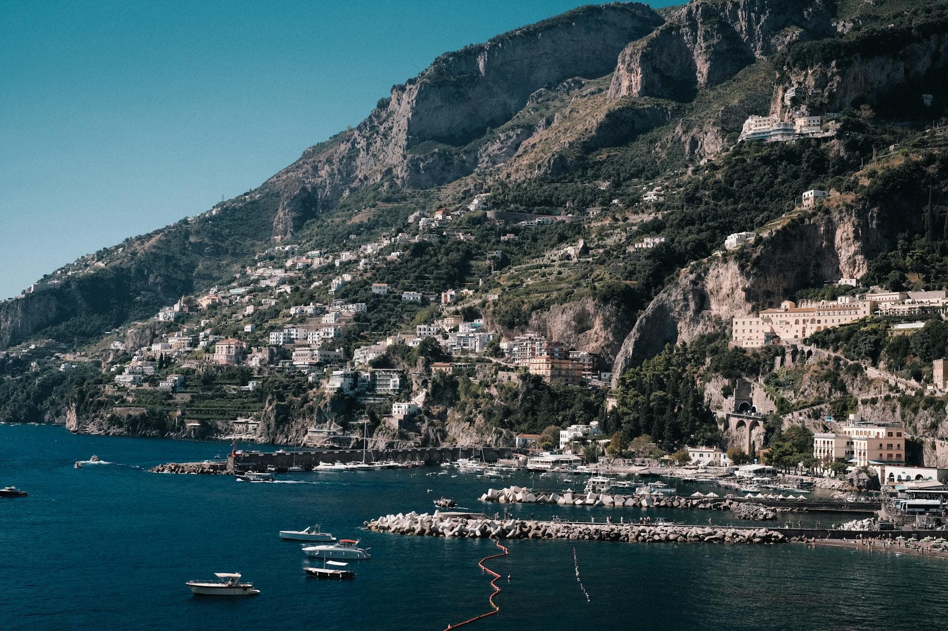Aerial view of the stunning Amalfi coastline with charming buildings and cliffs.