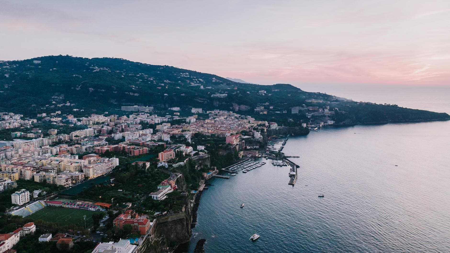 Scenic aerial view of Sorrento, Italy at sunset. A beautiful blend of cityscape and coastline.