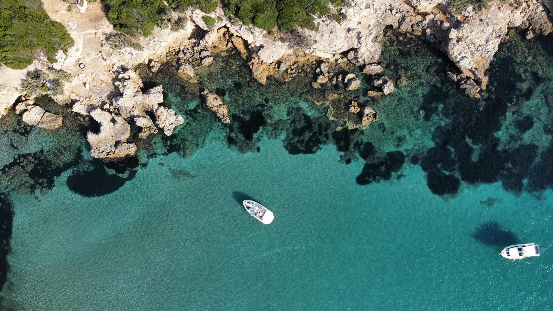 Stunning aerial view of the rocky coastline and turquoise waters in Sığacık, İzmir, Turkey.