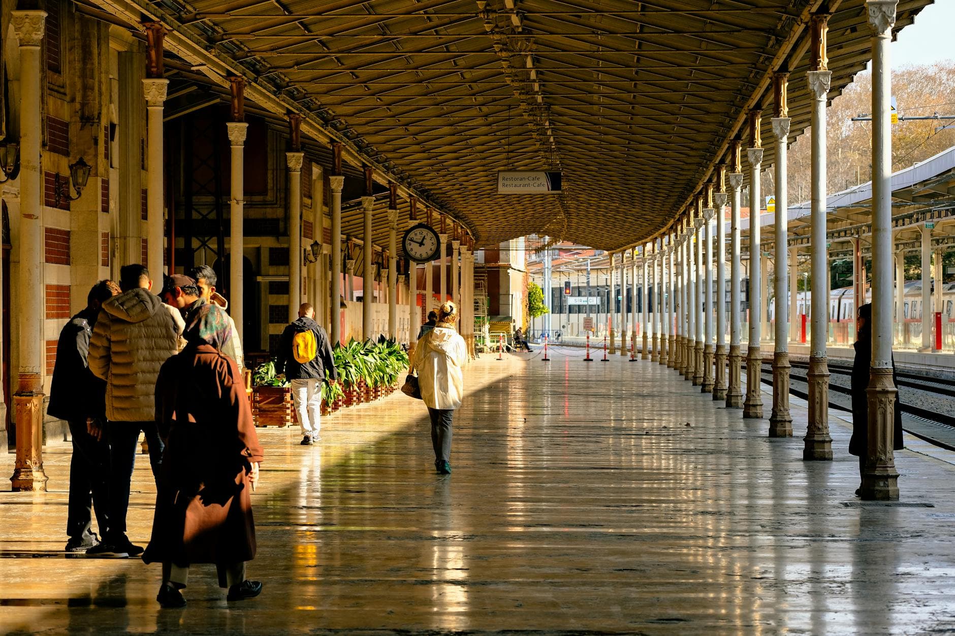 People walking and waiting at Sirkeci Train Station in Istanbul, capturing urban travel essence.