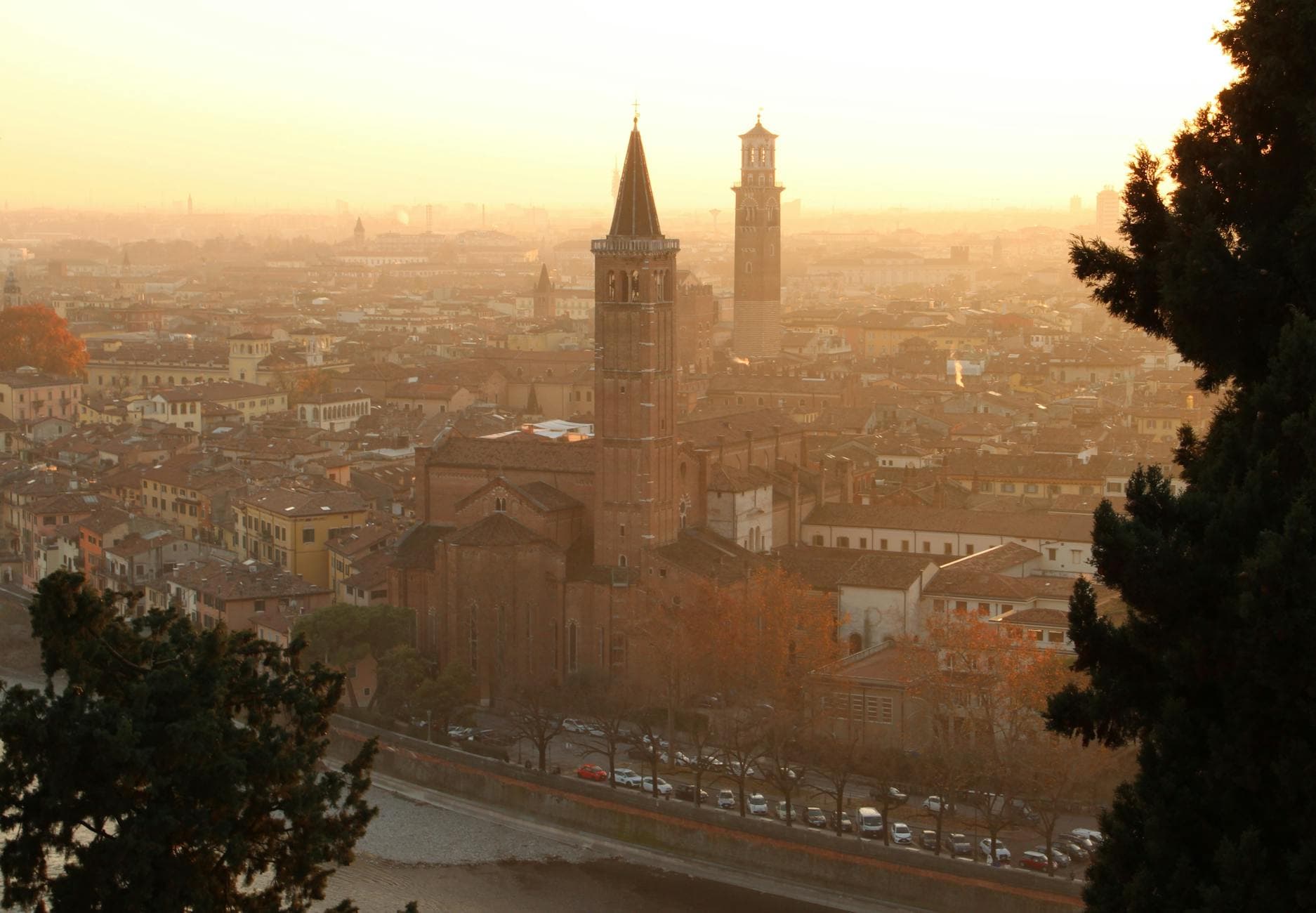 Aerial view of Verona at sunset showcasing the city's iconic towers and architecture.