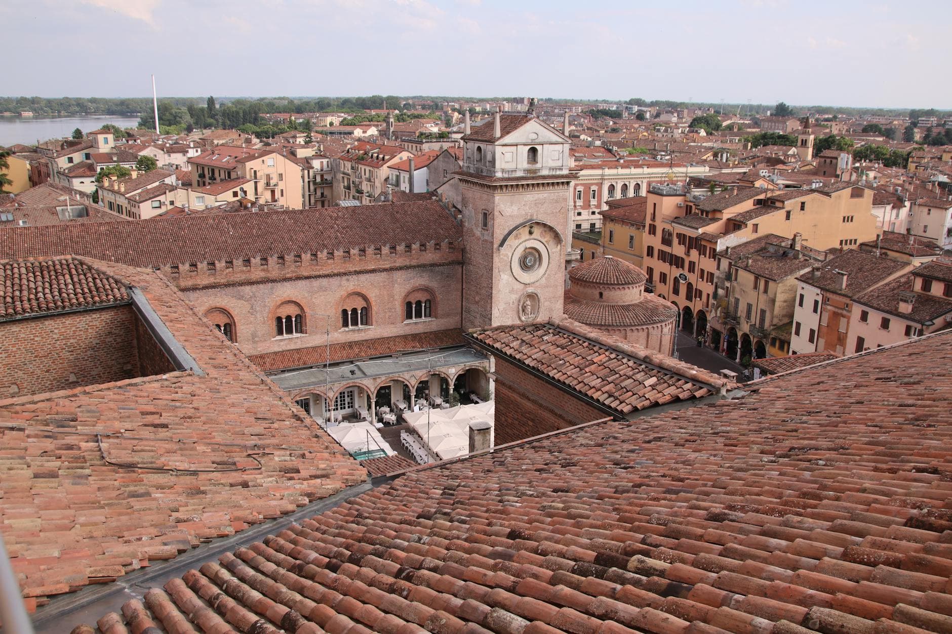 Aerial view of Mantova's historic architecture, featuring a basilica amidst rustic rooftops.