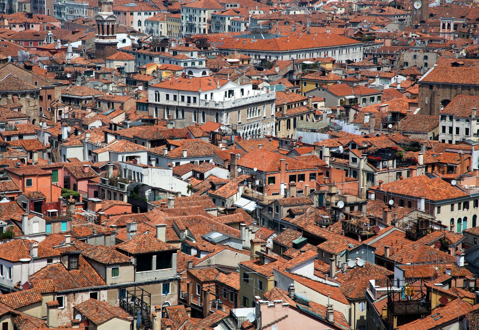 Aerial shot showcasing the iconic red rooftops of Venice, Italy, capturing the city's classic architectural style.