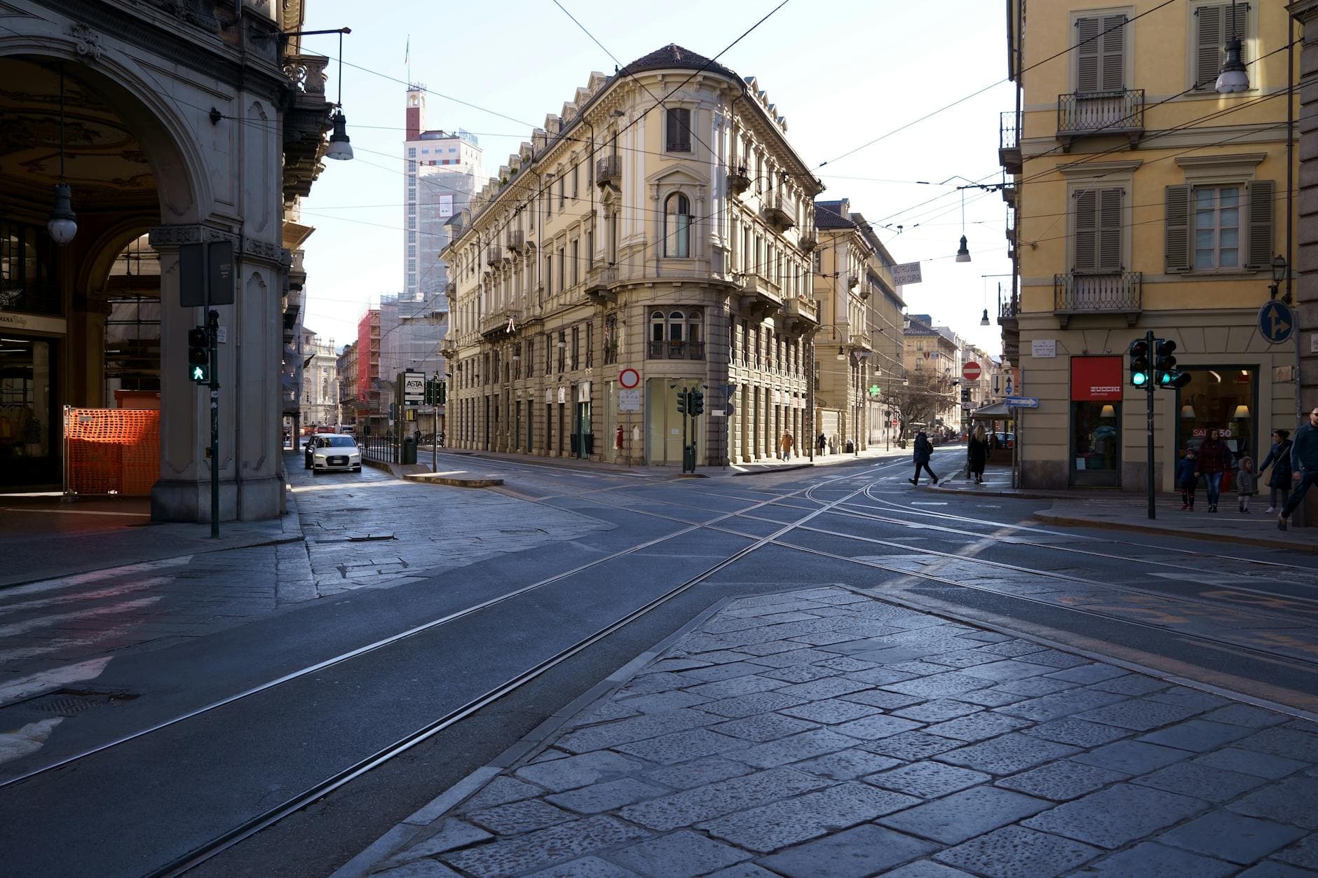 A vibrant sunny day in the urban streets of Turin, Italy, showcasing classic architecture.