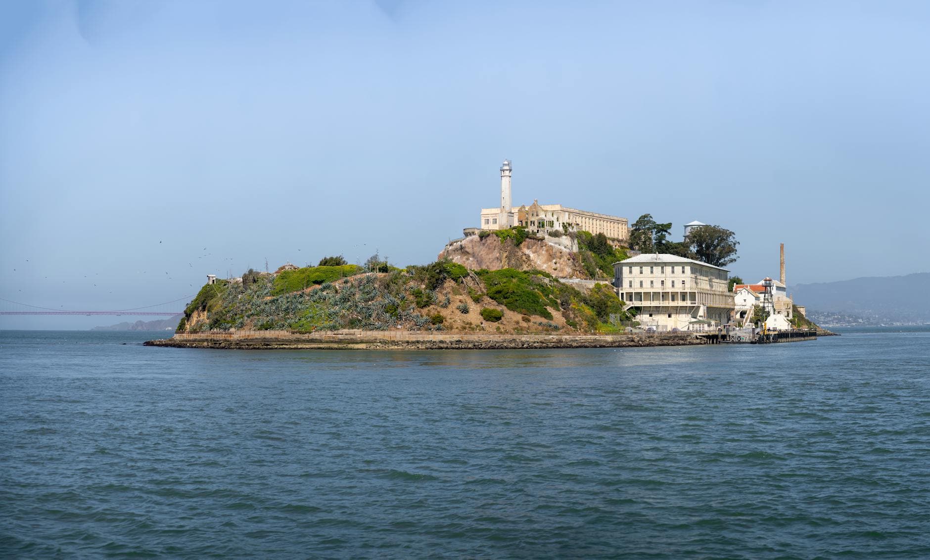 A scenic view of Alcatraz Island and its historic buildings in San Francisco Bay.