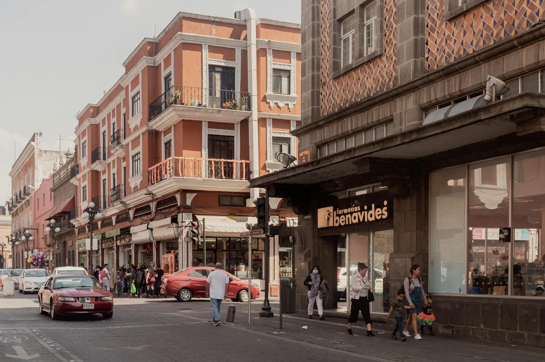 Bustling street in Puebla, showcasing local architecture and lively pedestrian activity.
