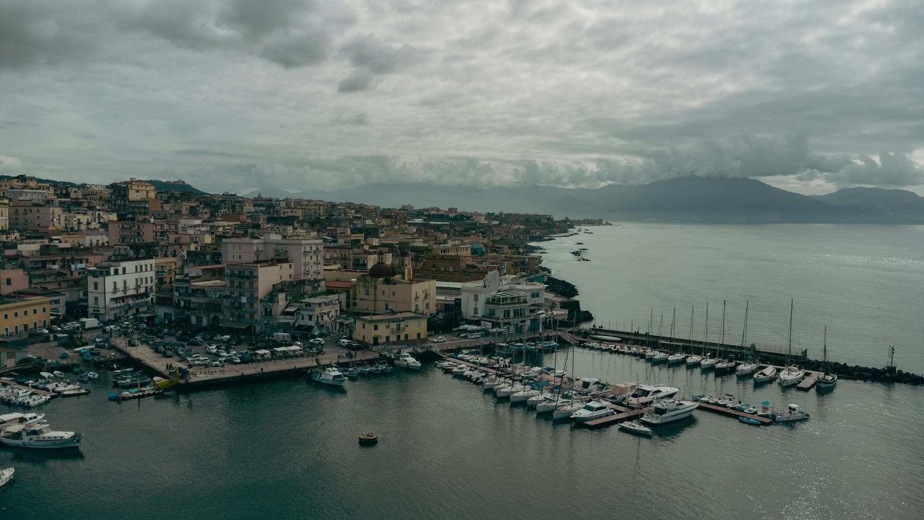 Stunning aerial shot of Naples, Italy, showcasing the historic port, coastal landscape, and vibrant cityscape.