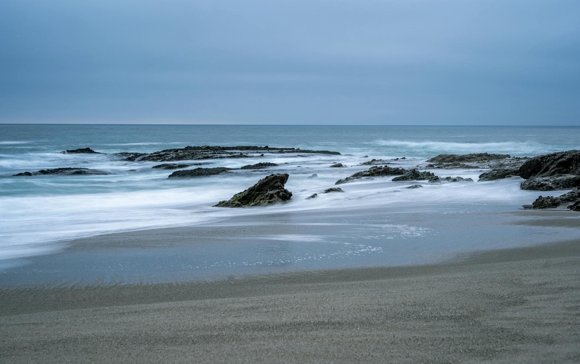 Peaceful view of waves and rocks at Laguna Beach, perfect for a calm escape.