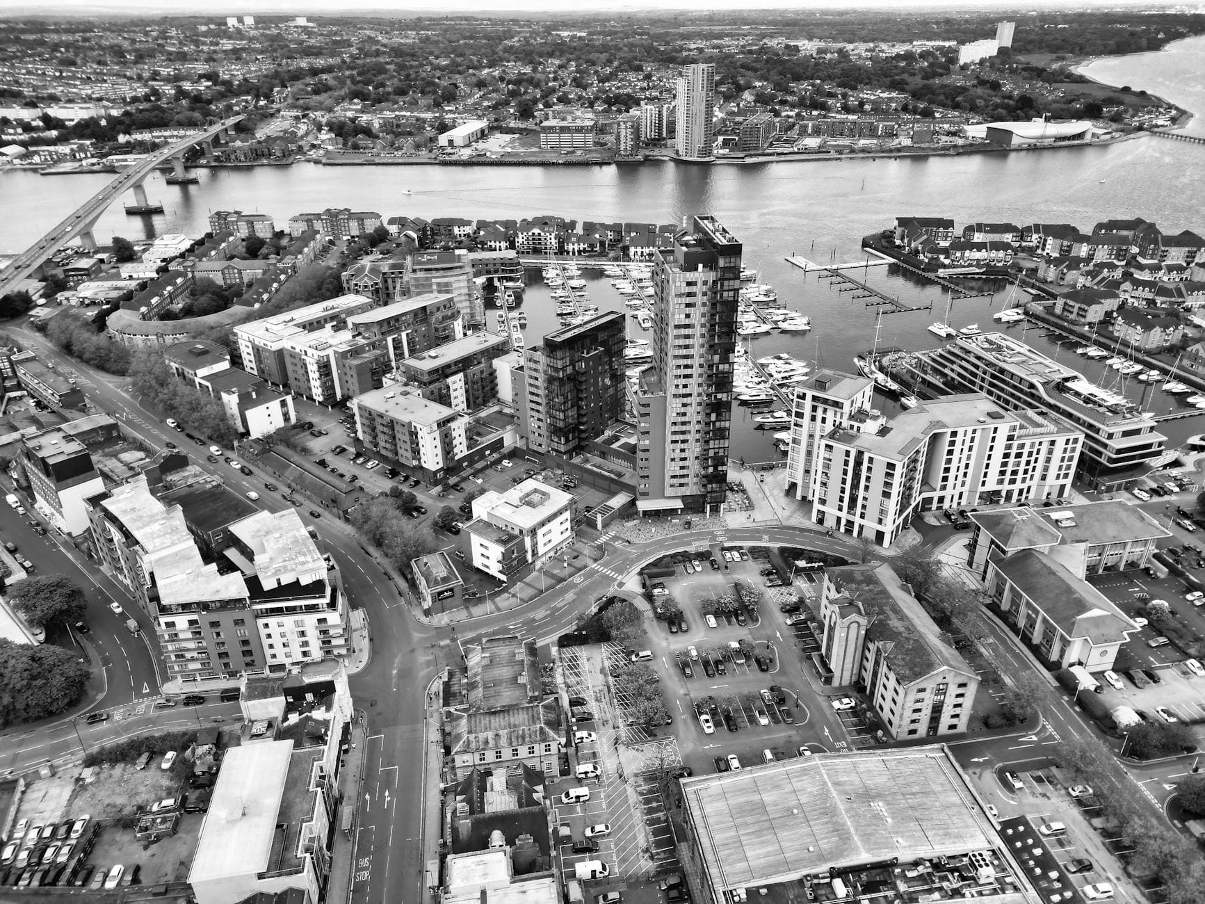 Black and white aerial view of the bustling waterfront and urban landscape of Southampton Marina.