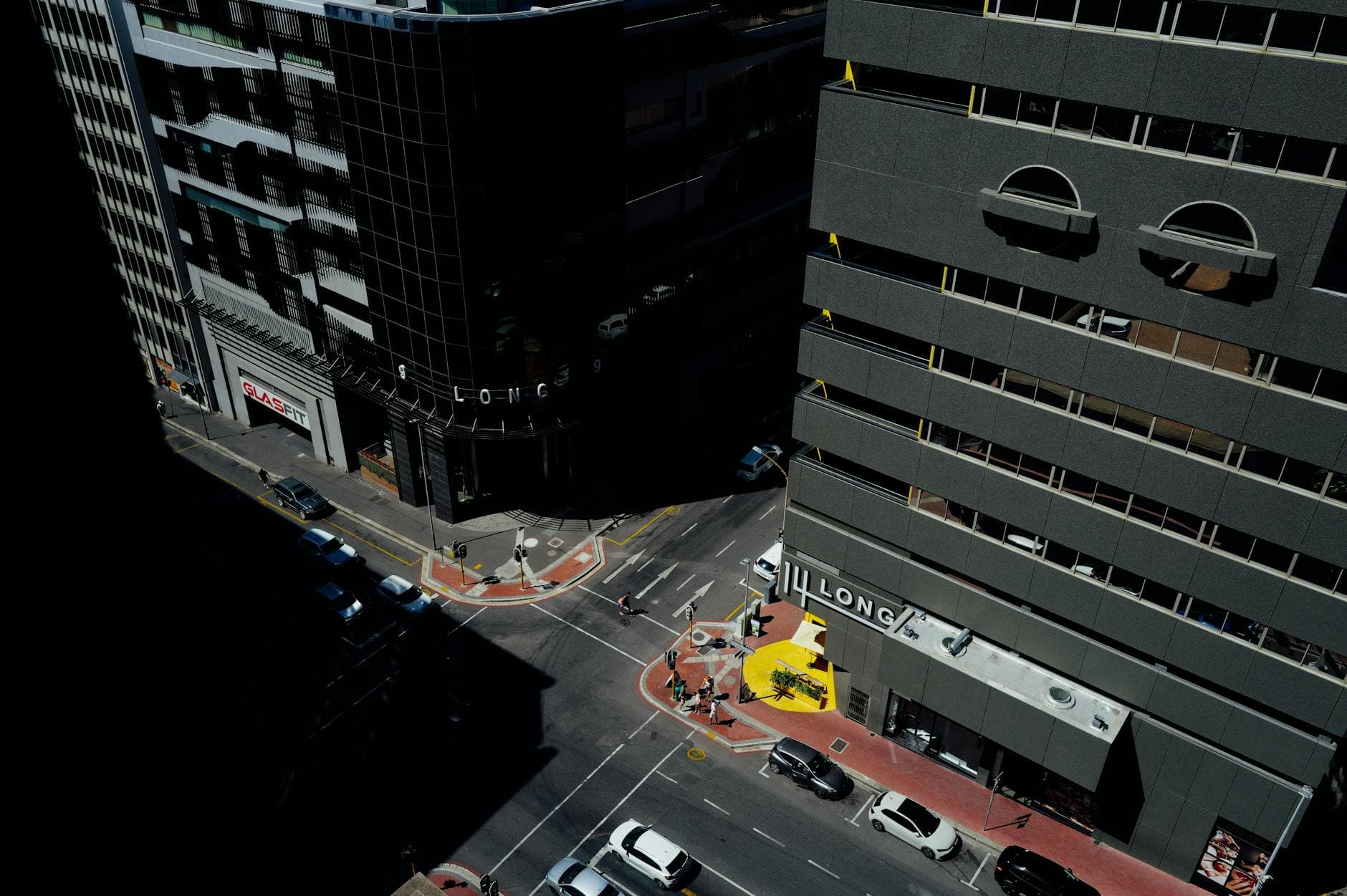 High-angle urban street view with modern buildings and city traffic.