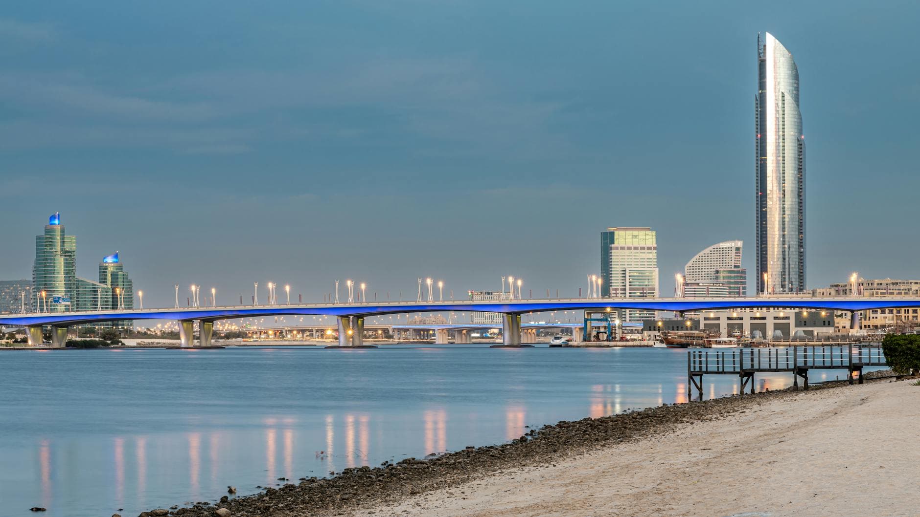 Cityscape showcasing Al Garhoud Bridge and iconic Dubai skyline at twilight.
