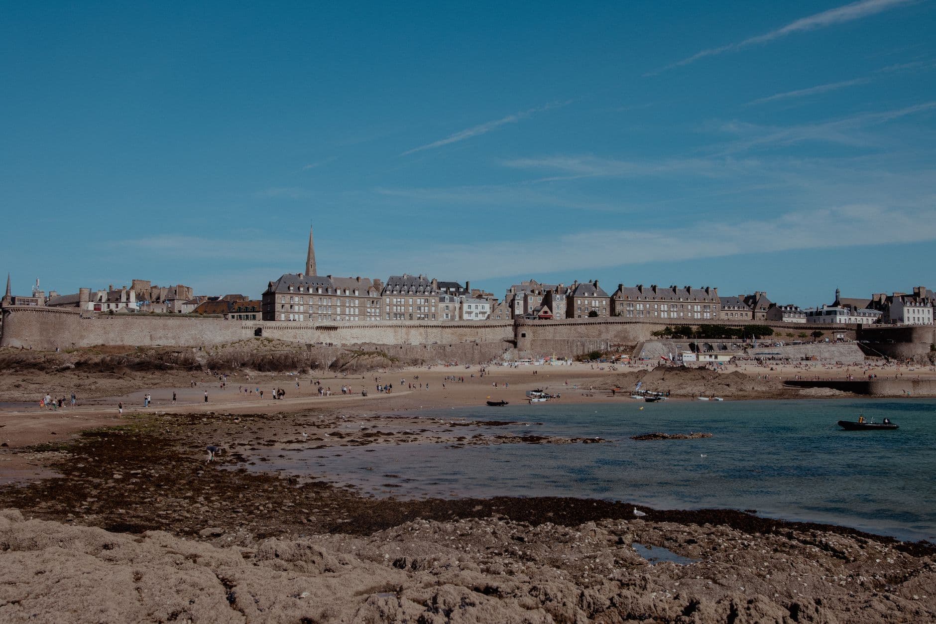A sunny day view of the historic walled city and beach in Saint-Malo, Brittany.