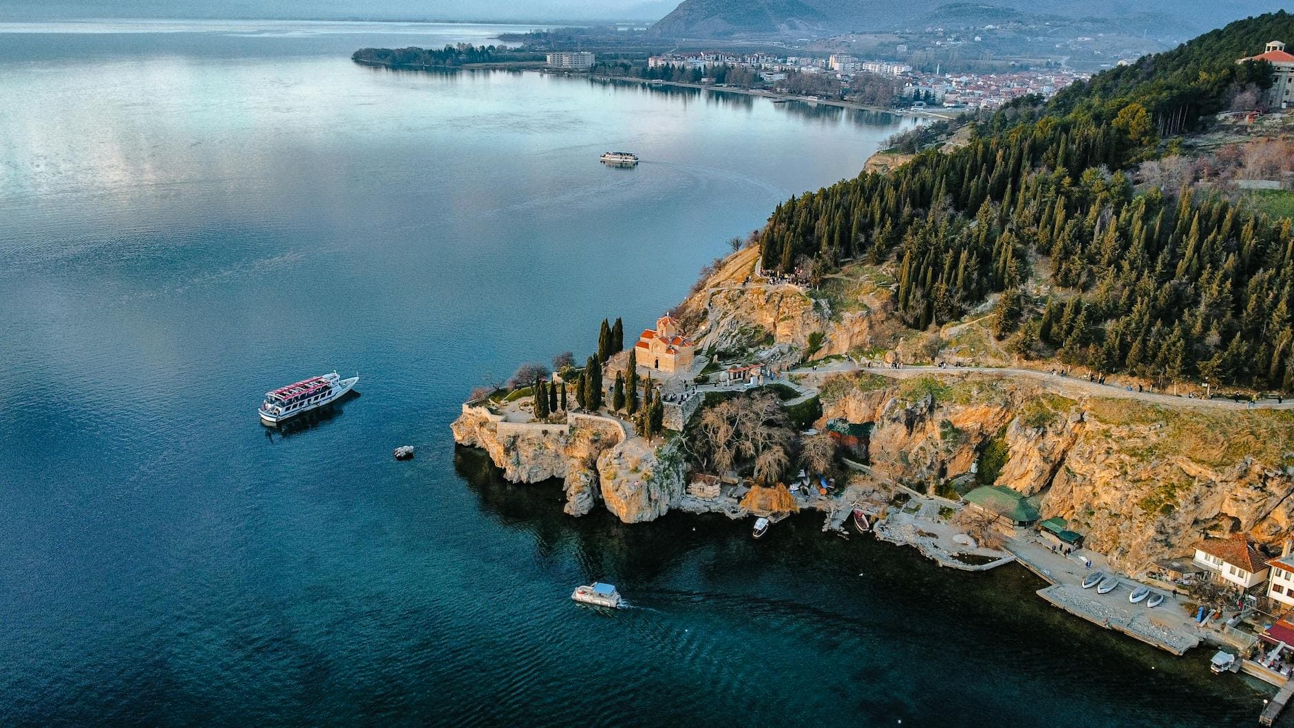 Stunning aerial view of Lake Ohrid, showcasing the historic St. John at Kaneo Church on the cliff.