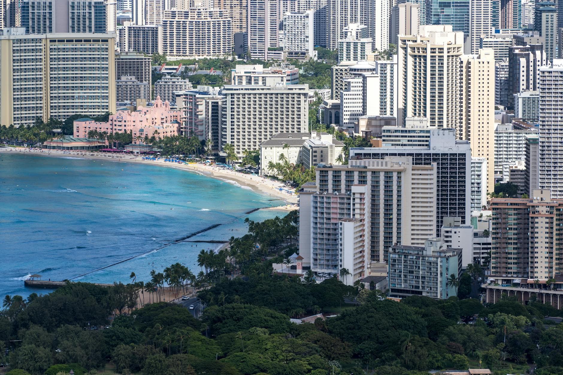 A stunning aerial view showcasing the skyline of Honolulu with Waikiki Beach in the foreground.