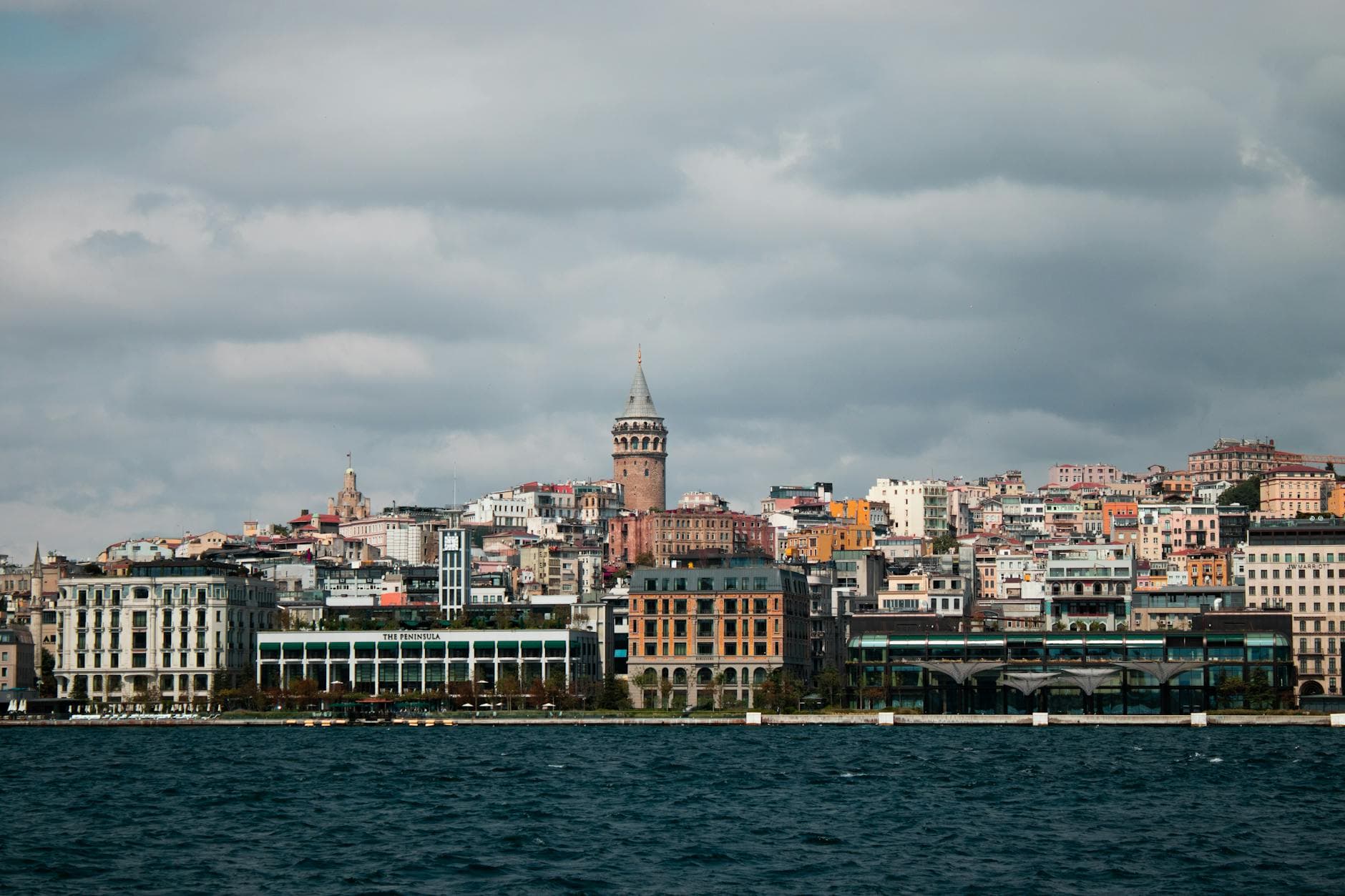 Scenic view of Istanbul's skyline featuring the iconic Galata Tower by the coast.