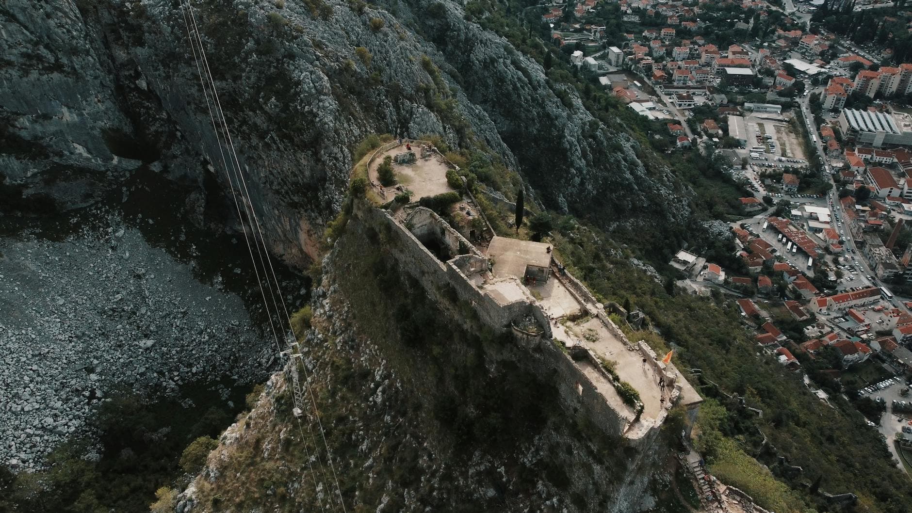 Stunning aerial view of a historic castle in Kotor, Montenegro overlooking the city and mountains.