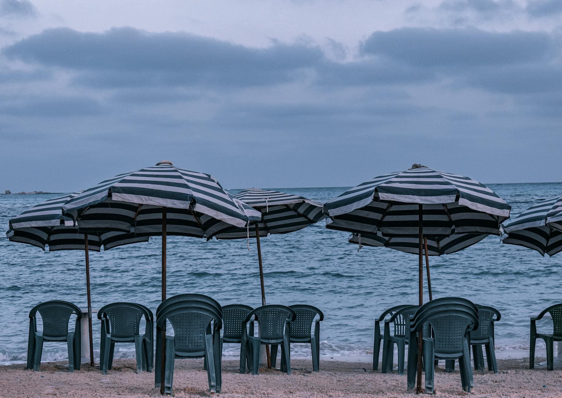 Chairs and umbrellas on Marsa Matruh beach in Egypt, showcasing a serene seaside view.