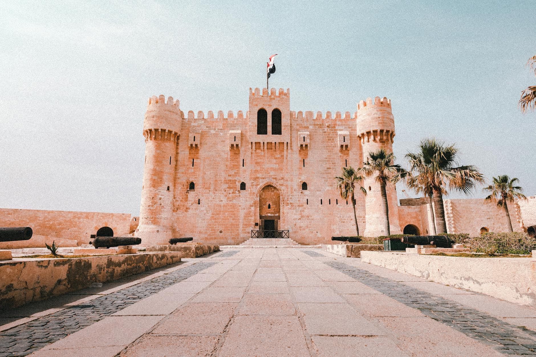 Majestic view of the medieval Citadel of Qaitbay in Alexandria, Egypt, under a clear sky.