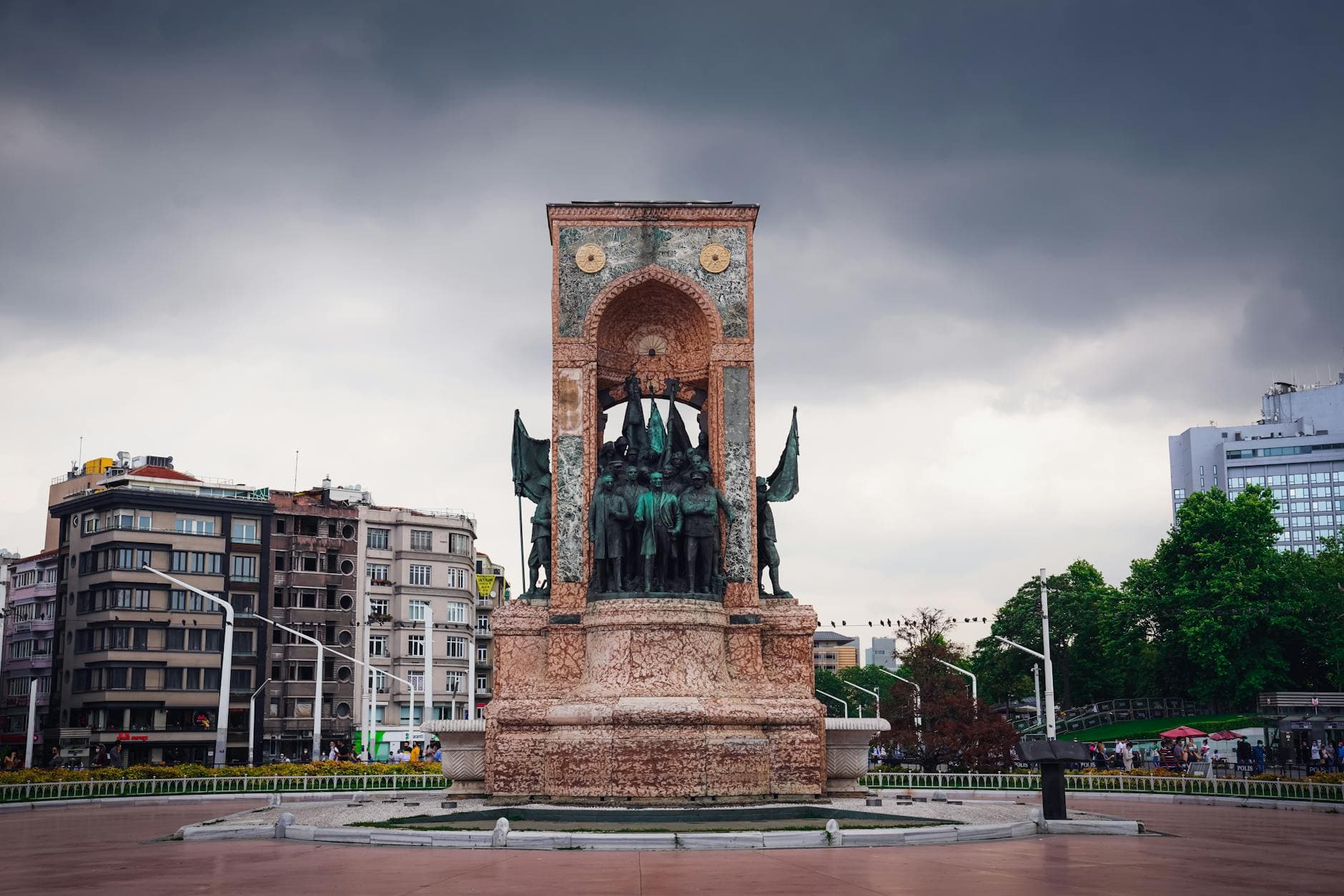 Historical monument in Taksim Square, Istanbul, captures a dramatic sky backdrop.