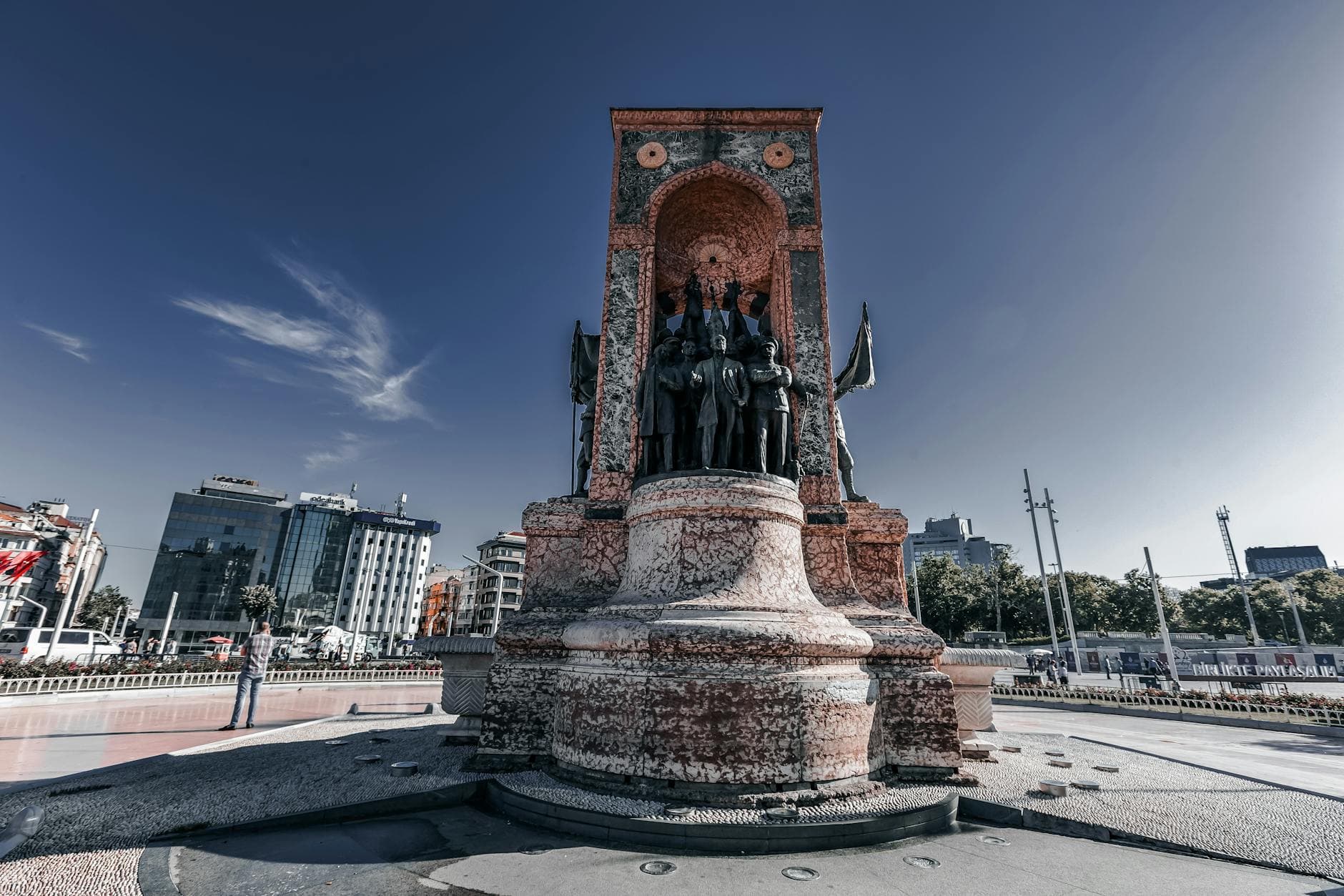 A striking view of the Republic Monument in Taksim Square, Istanbul during a clear day.