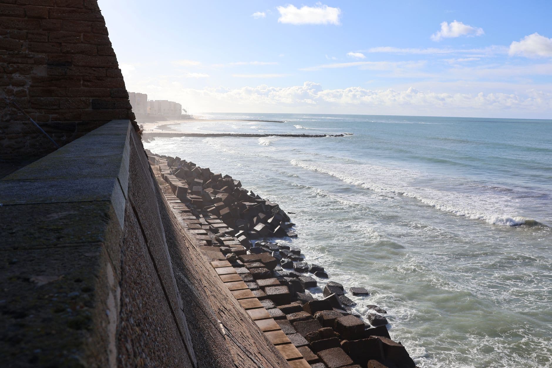 Capturing the rugged beauty of Cádiz's historic seawall and serene coastline.