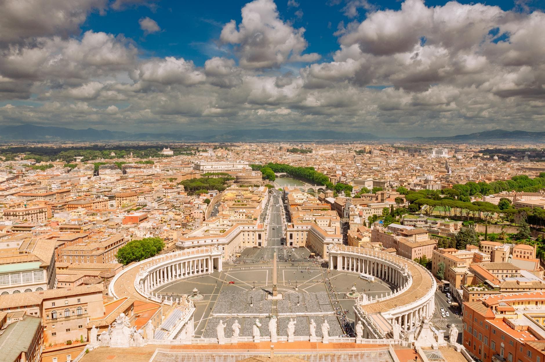 Stunning aerial shot of St. Peter's Square in Vatican City showing its iconic colonnades and Rome's skyline.