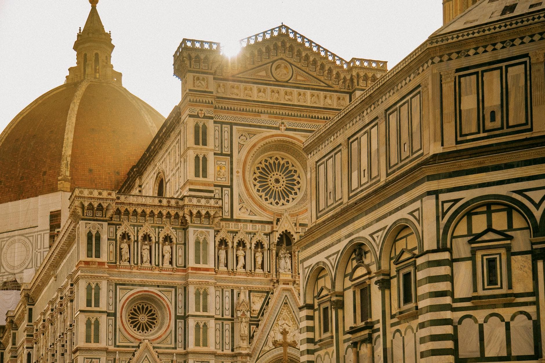 Beautiful view of Florence Cathedral's ornate Gothic facade and dome at sunset in Tuscany, Italy.