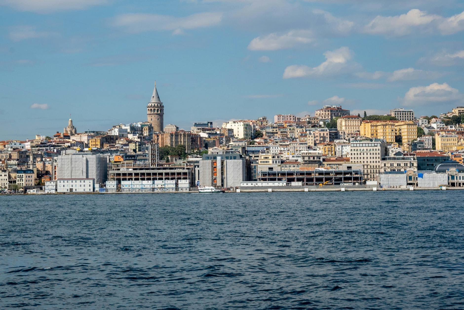 Discover the stunning urban skyline of Istanbul with the iconic Galata Tower and bustling waterfront.