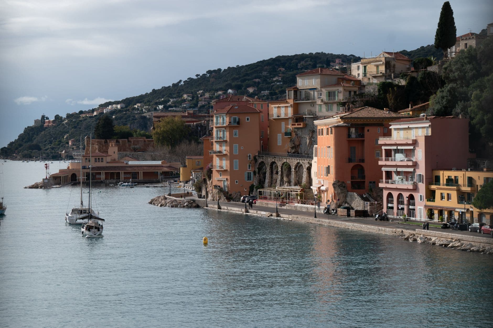 Picturesque coastal view of Villefranche-sur-Mer in the French Riviera, showcasing colorful buildings and calm waters.