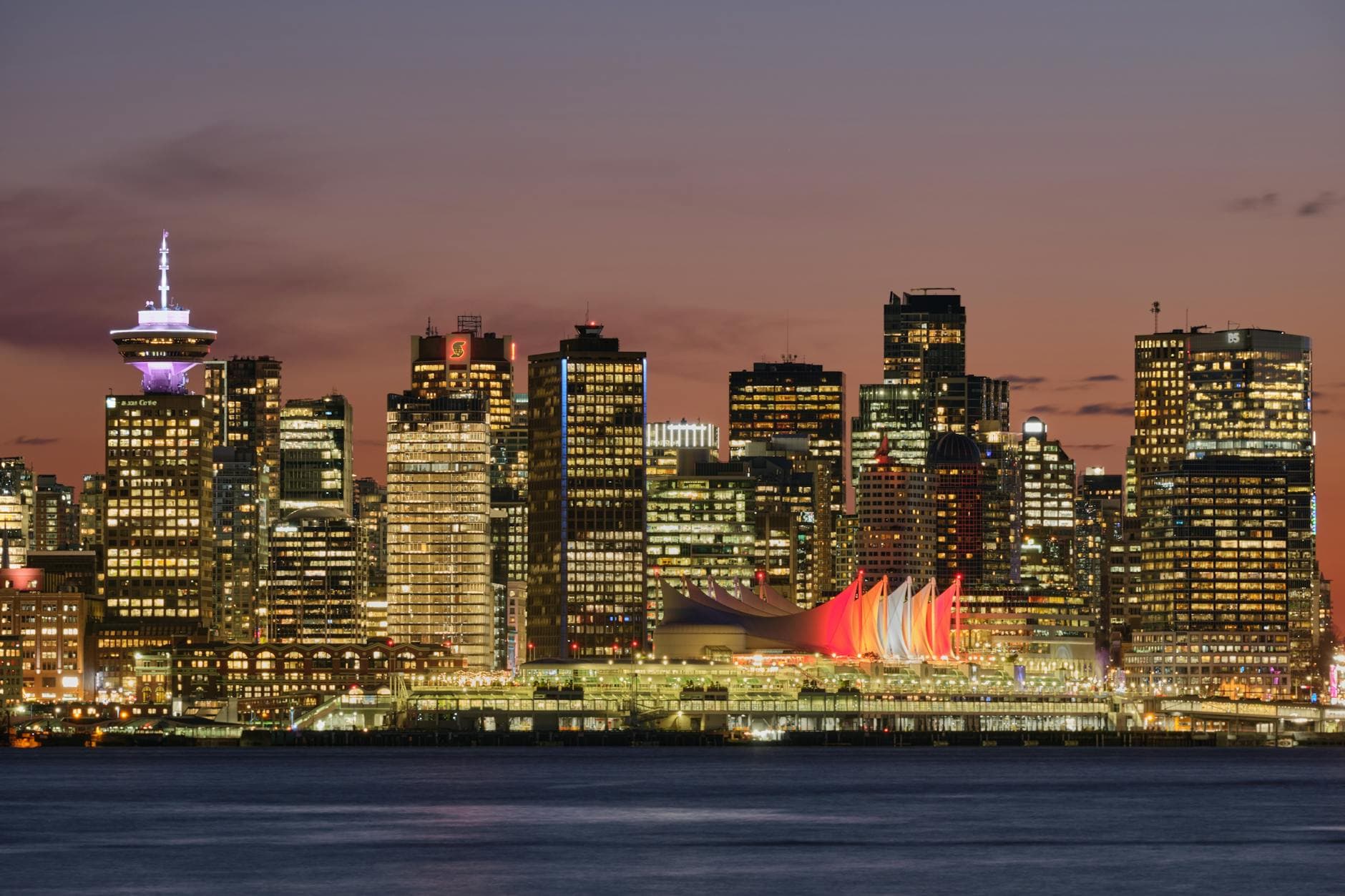 Stunning twilight view of Vancouver's illuminated downtown skyline and waterfront.
