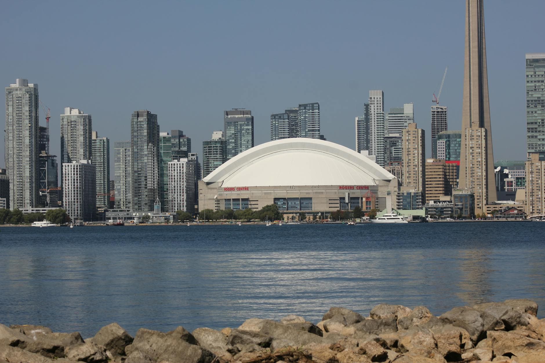 Skyline of Toronto with CN Tower and Rogers Centre by the waterfront.