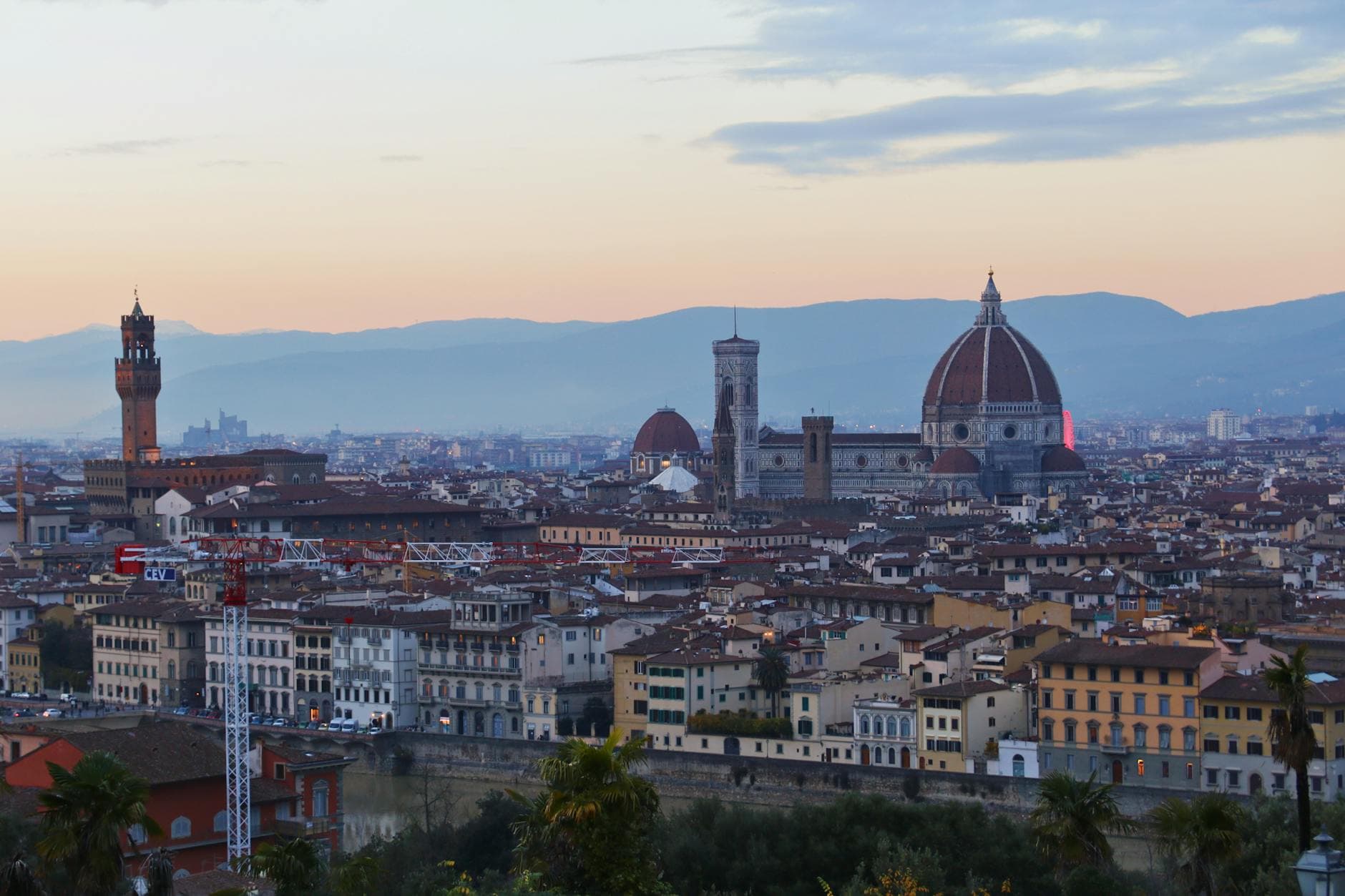 Scenic view of Florence, Italy featuring the iconic Duomo and city rooftops at sunset.