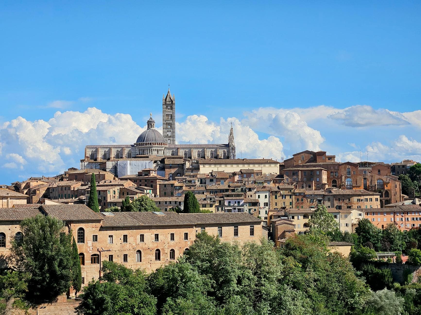 Stunning panoramic view of Siena Cathedral and surrounding medieval architecture in Tuscany, Italy.