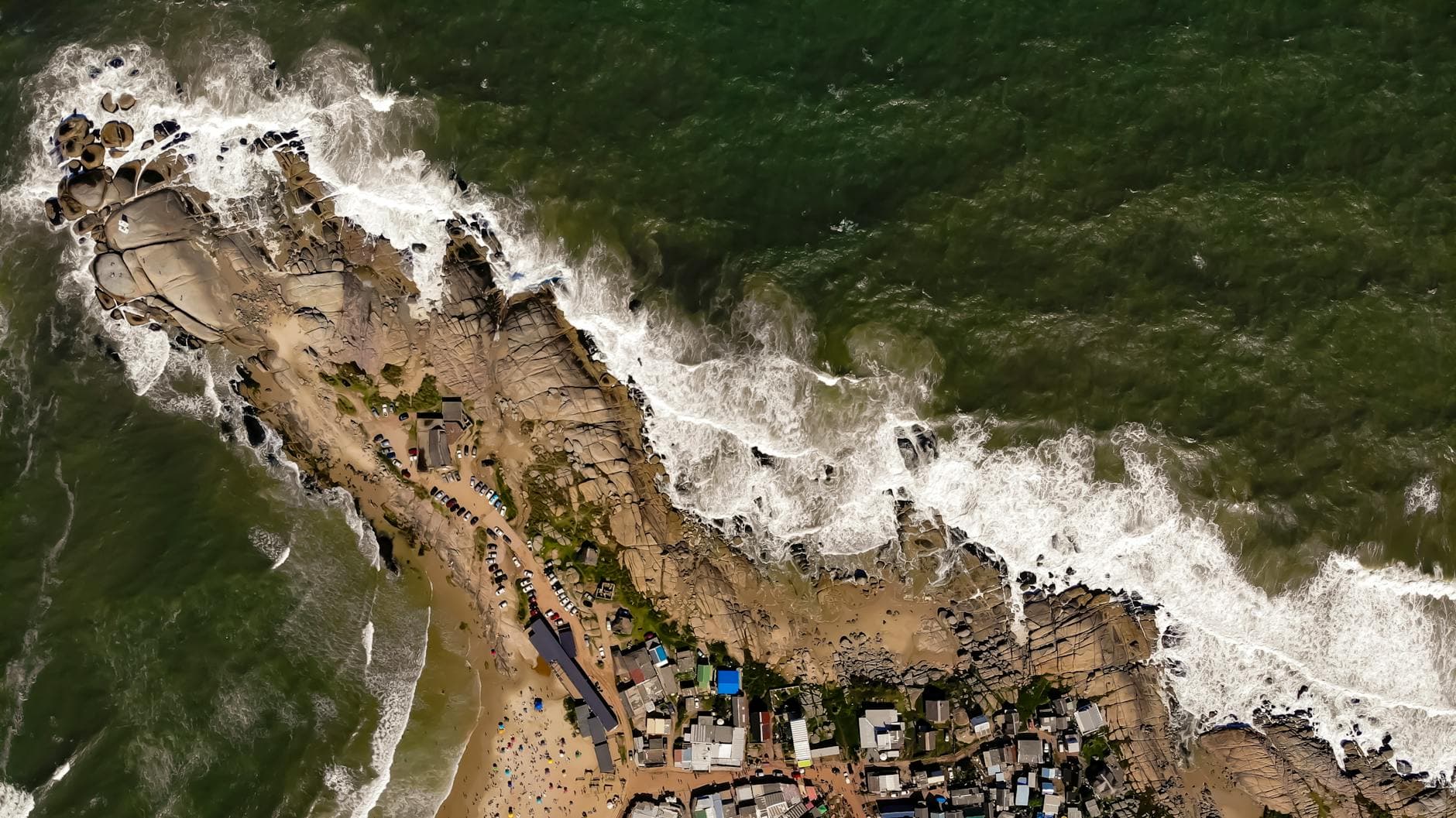 Stunning aerial view of Punta del Diablo's rugged coastline and ocean waves in Uruguay.