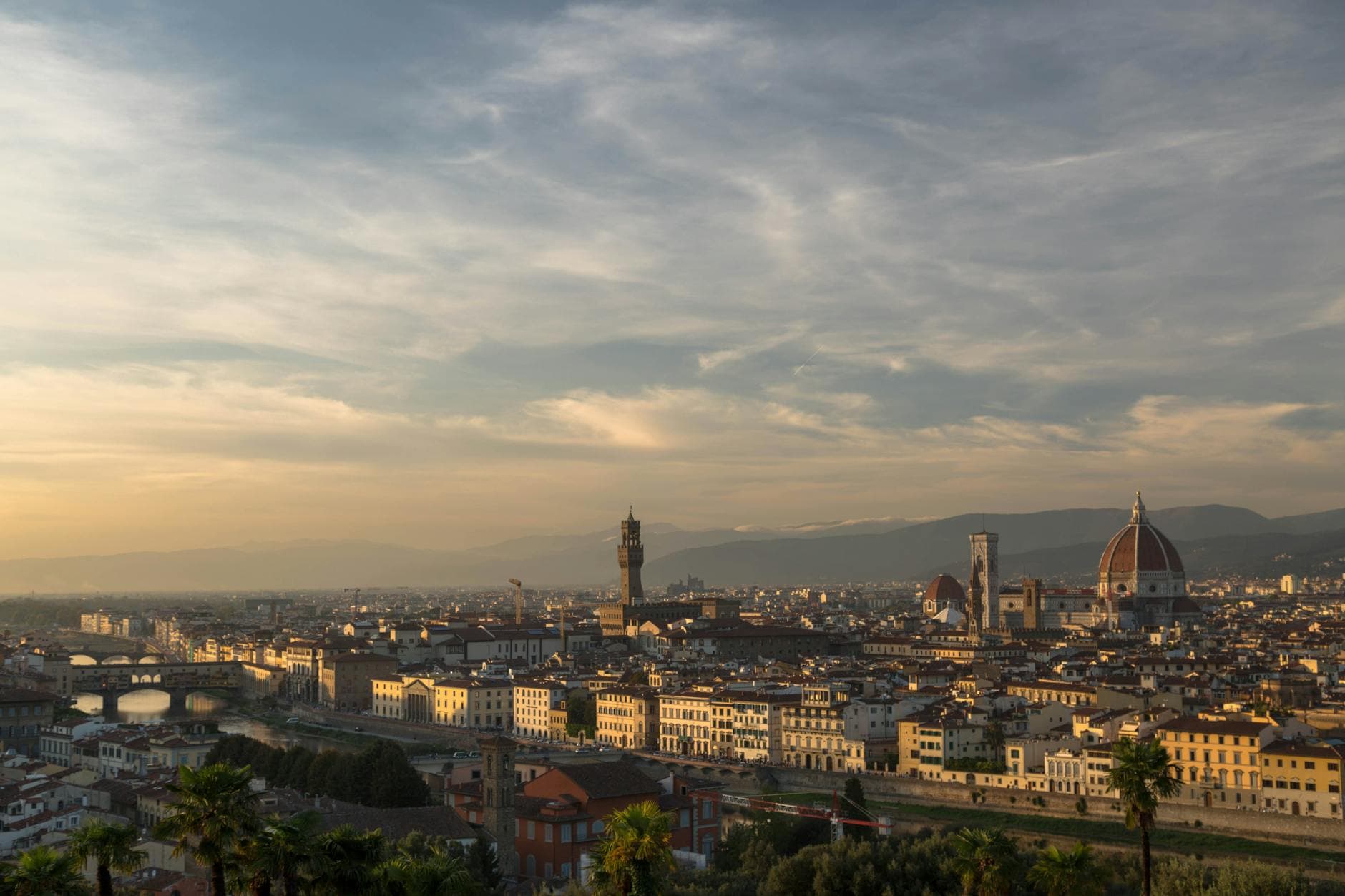 Panoramic view of Florence at sunset featuring the famous Duomo and historical architecture.